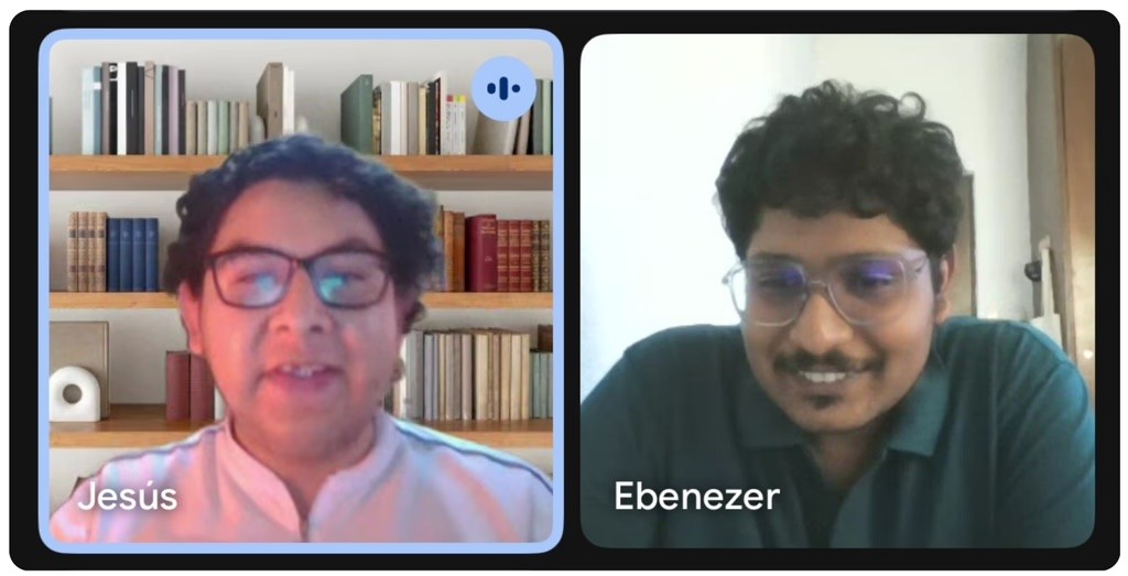 man in blue dress shirt smiling beside woman in black and red floral dress