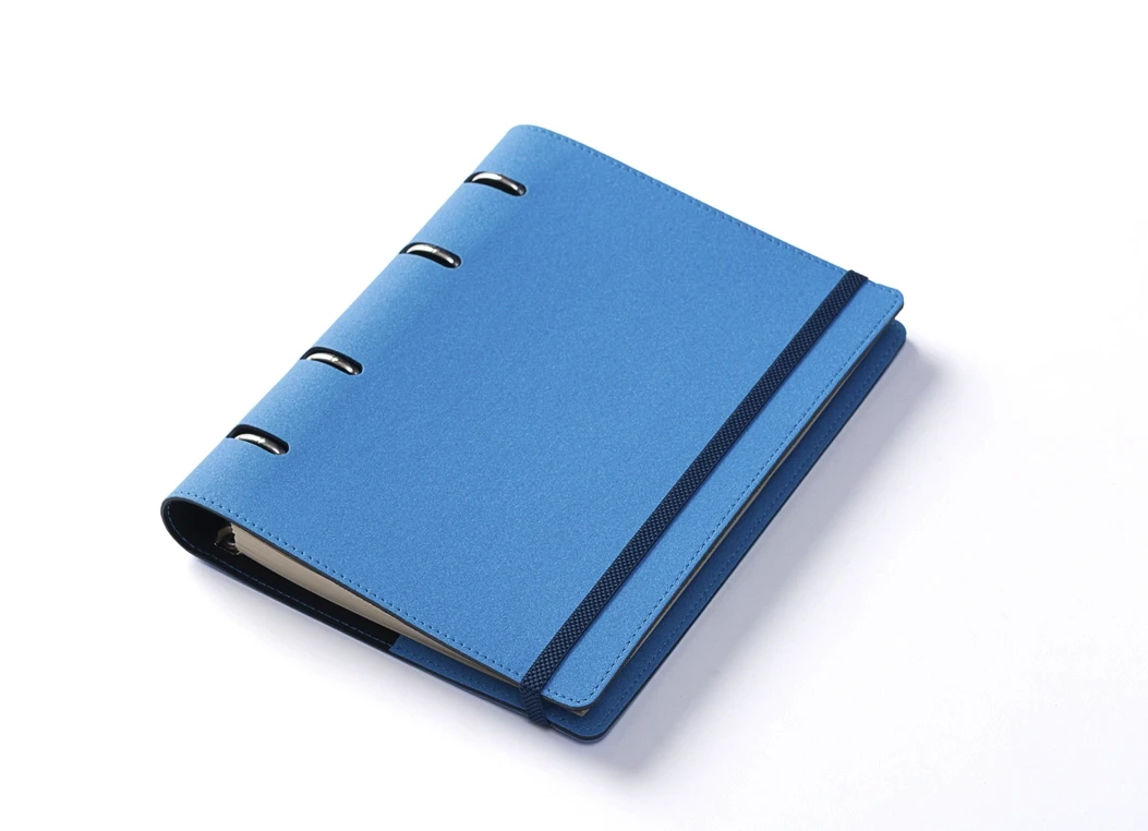 Blue ring binder journal with elastic closure, angled view
