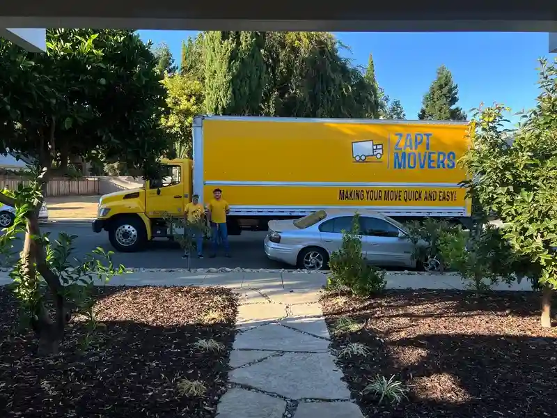 Yellow Zapt Movers truck parked for a residential move