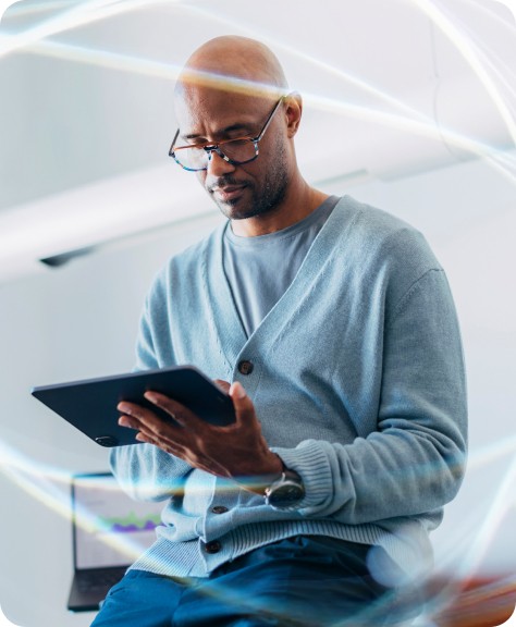 A focused male executive using a tablet to analyze business time management data and company productivity metrics in a modern office setting.