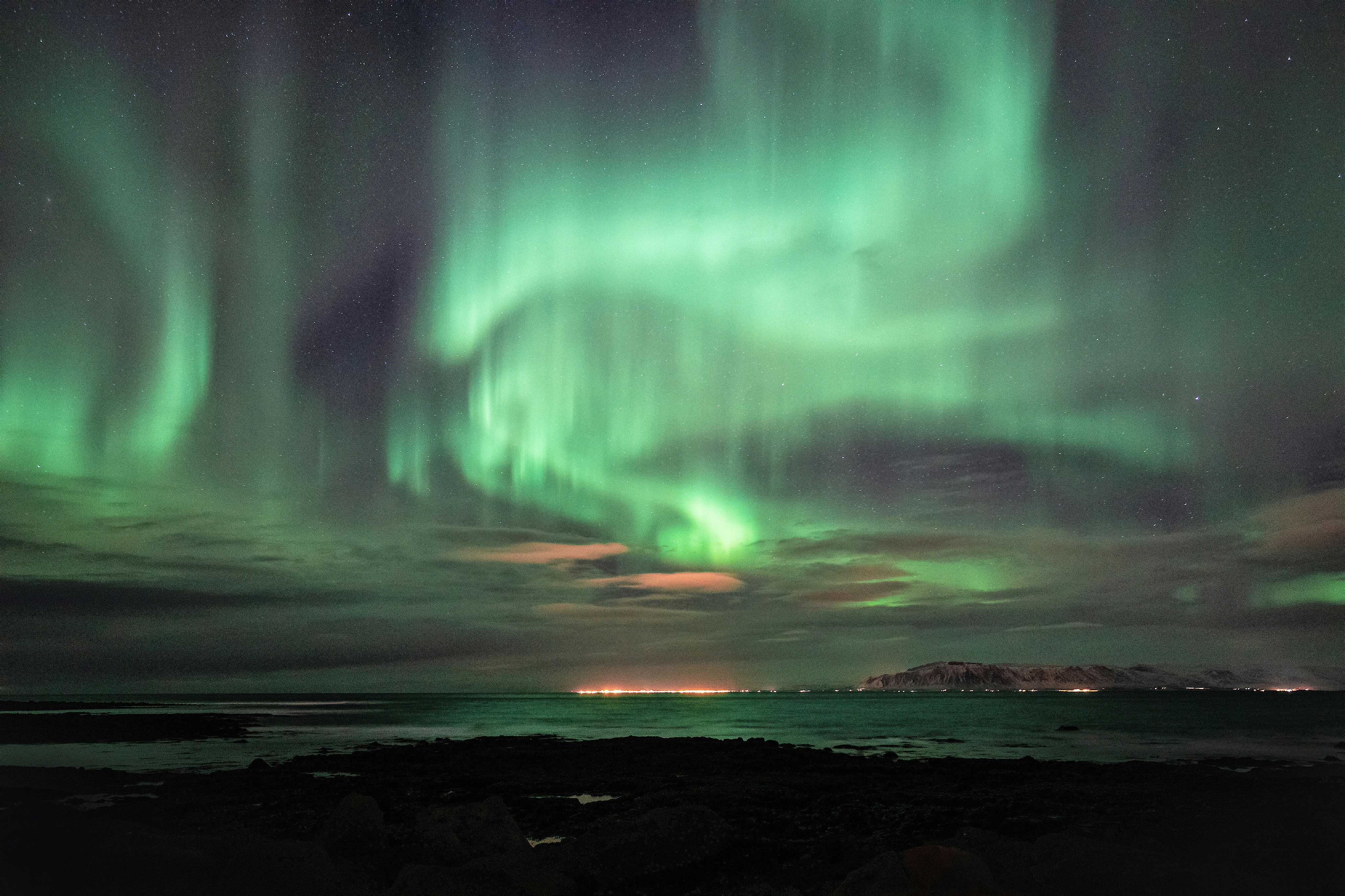 Northern lights seen from the shoreline of Reykjavík.