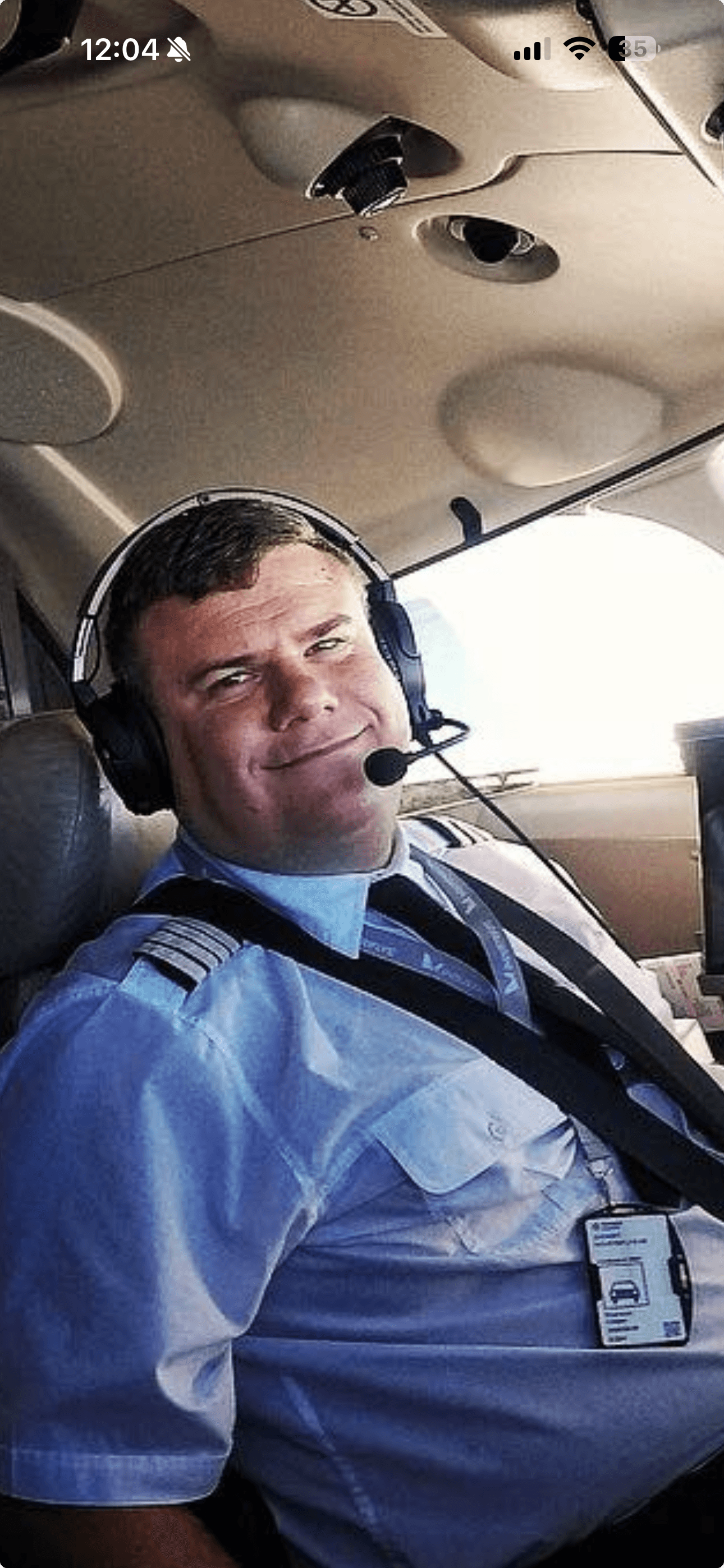 a man with a goatee smiles at the camera