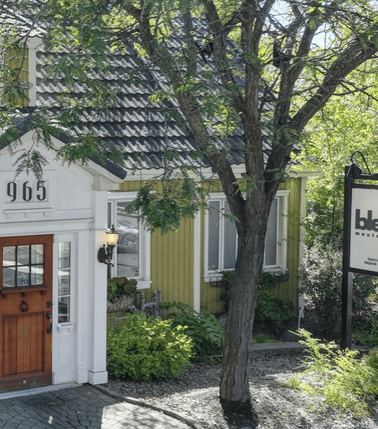 Restaurant exterior with black facade and welcoming atmosphere.