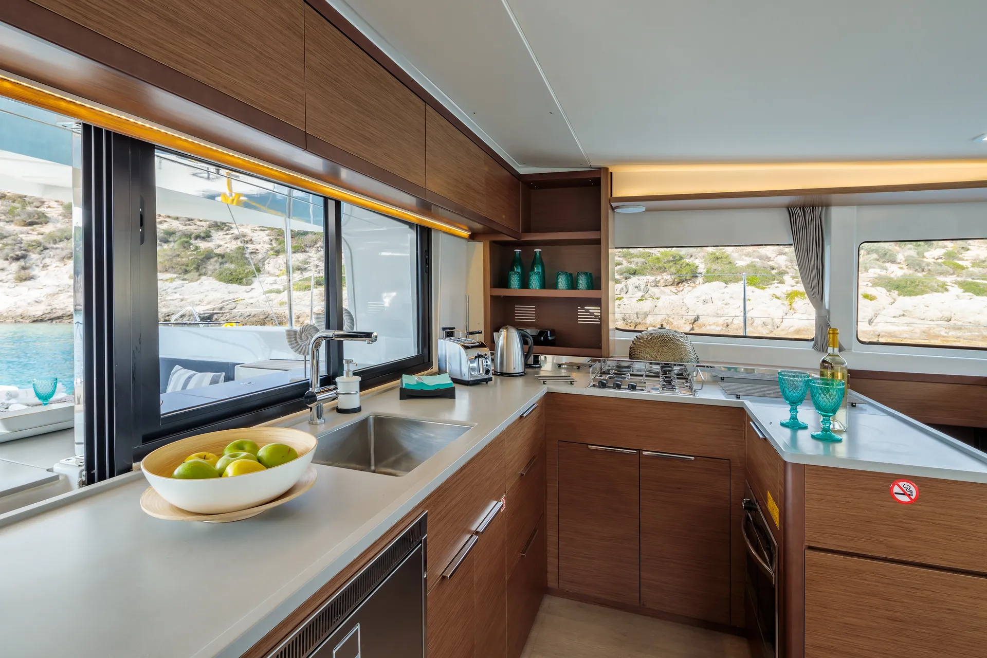 White Rock 36 speedboat with captain at helm cruising calm blue waters near Paros coastline with hills in background.
