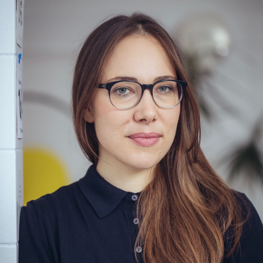a man with a goatee smiles at the camera