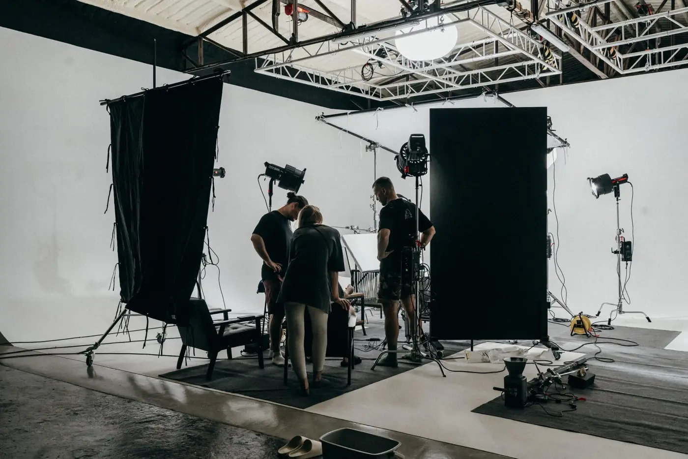 Backstage view of the set with black flags, lights and crew on the cyclorama at MStudio