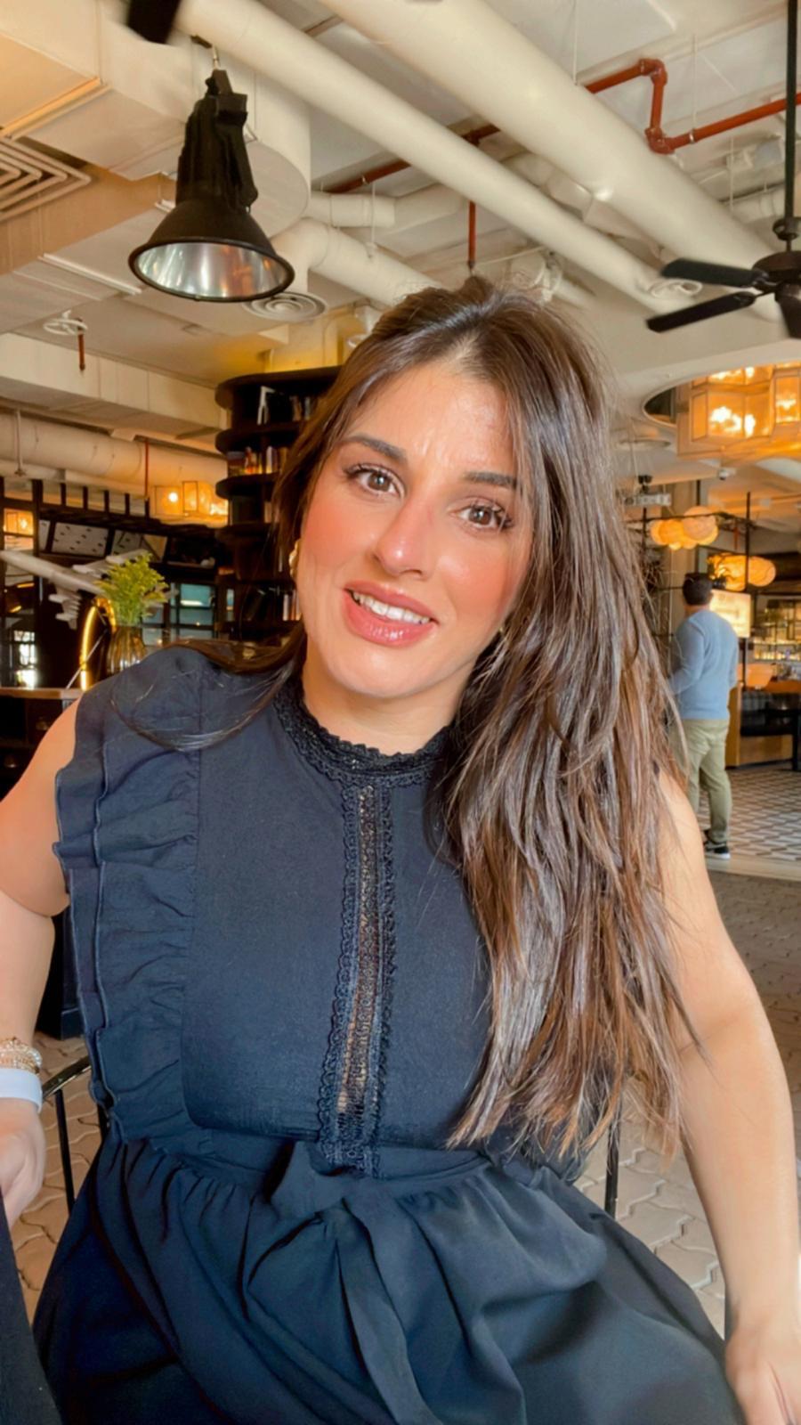 A smiling happy customer with curly hair on a blue background