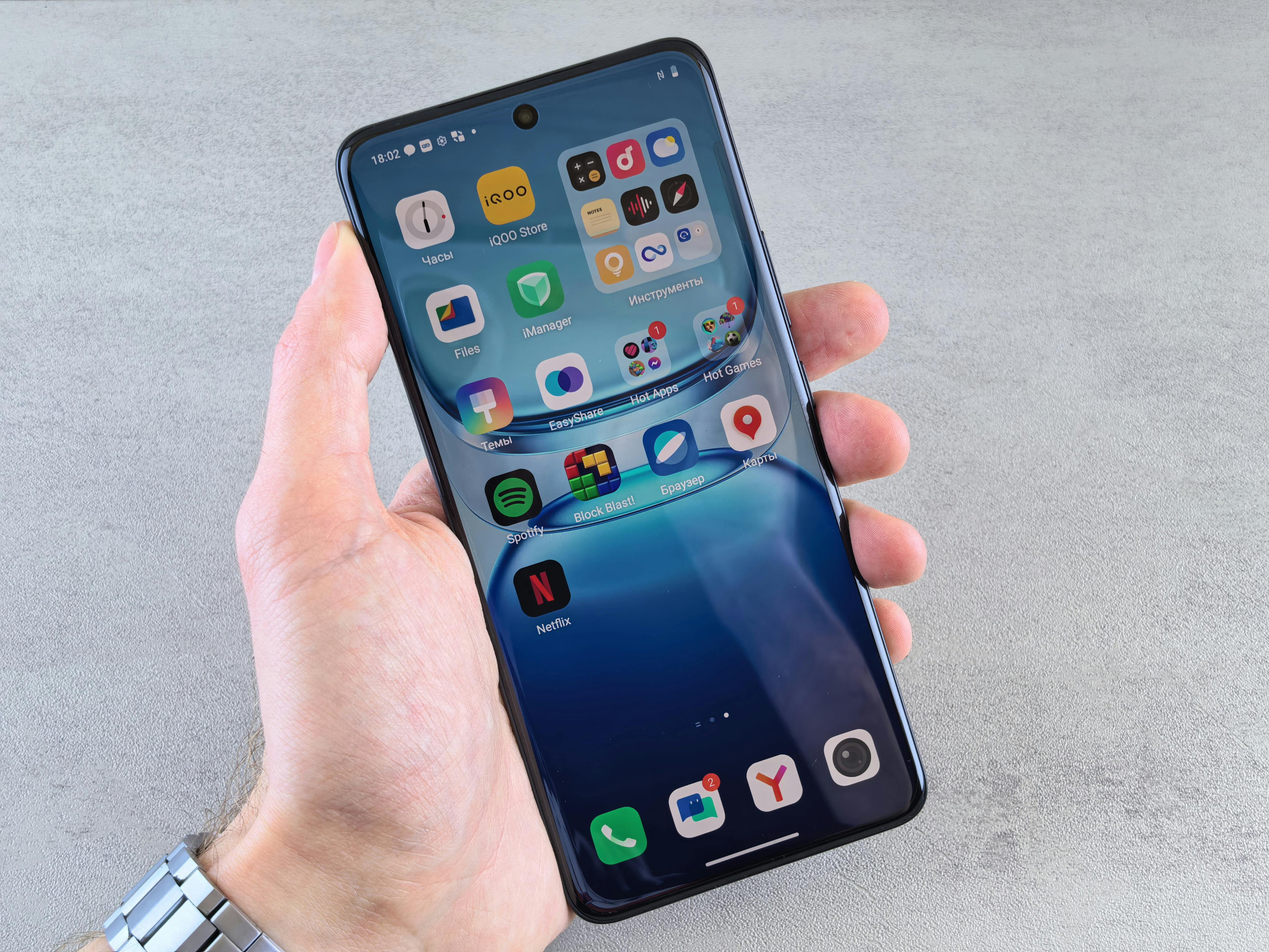 Man Holding Smartphone with App Icons Displayed