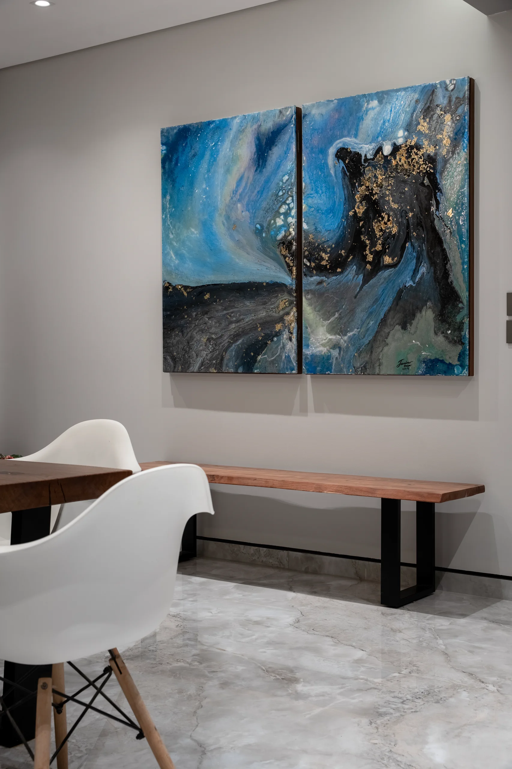 Dining-area artwork, walnut bench and contemporary detailing at Caesar SODIC Villa.