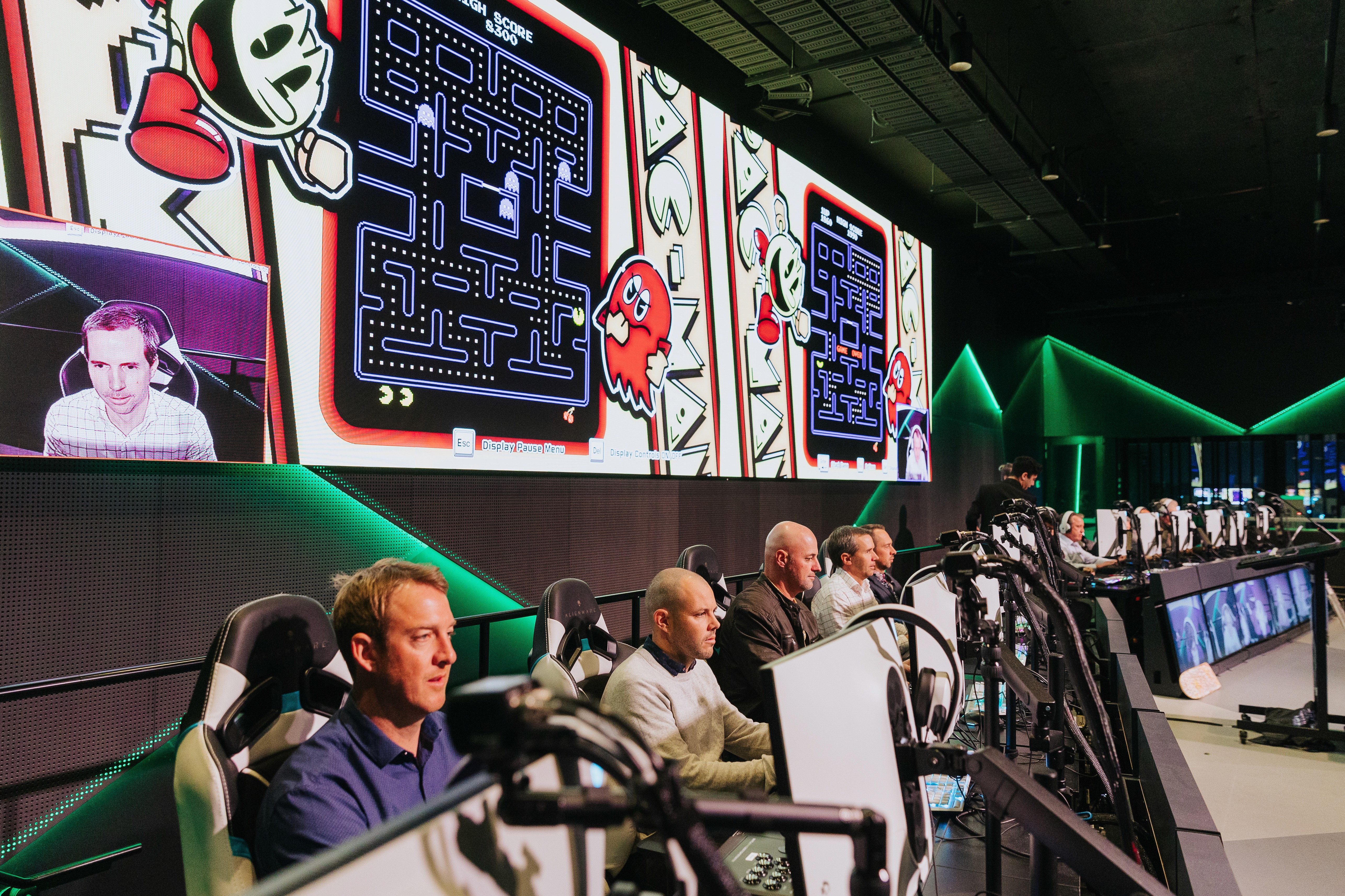 A conference with people playing pac man at Fortress