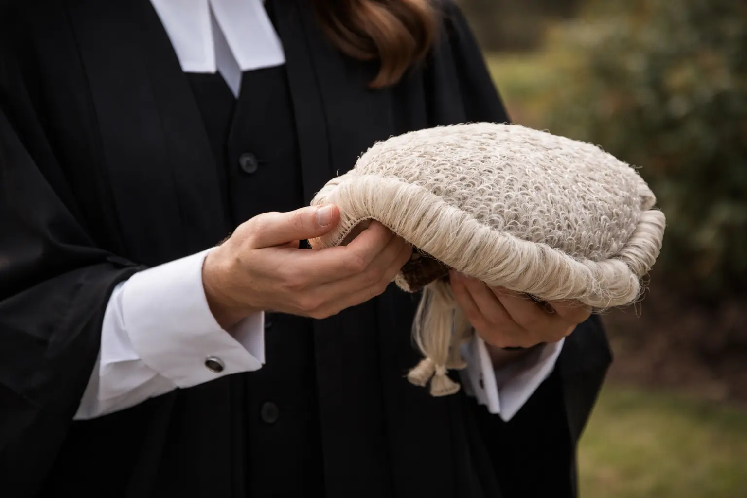 Lawyer holding a wig.
