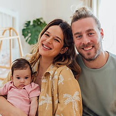 Man and woman with newborn child at home
