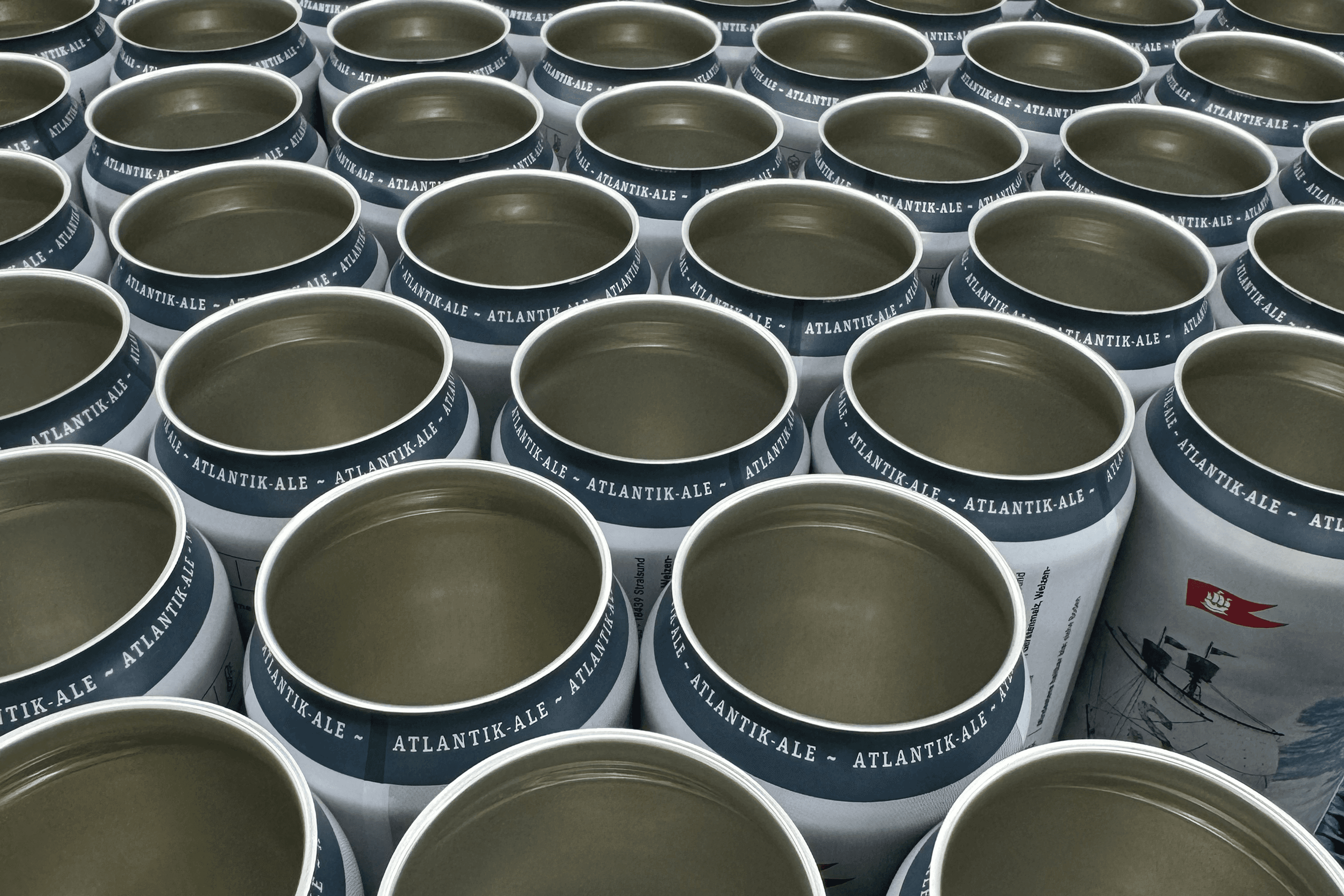 Rows of empty "ATLANTIK-ALE" beer cans.