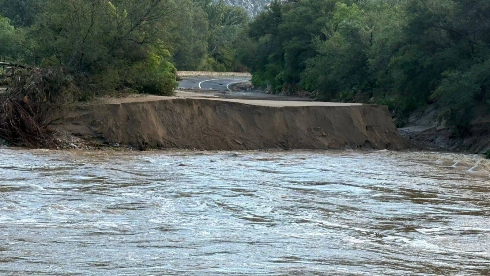 Road washed away by flood waters.