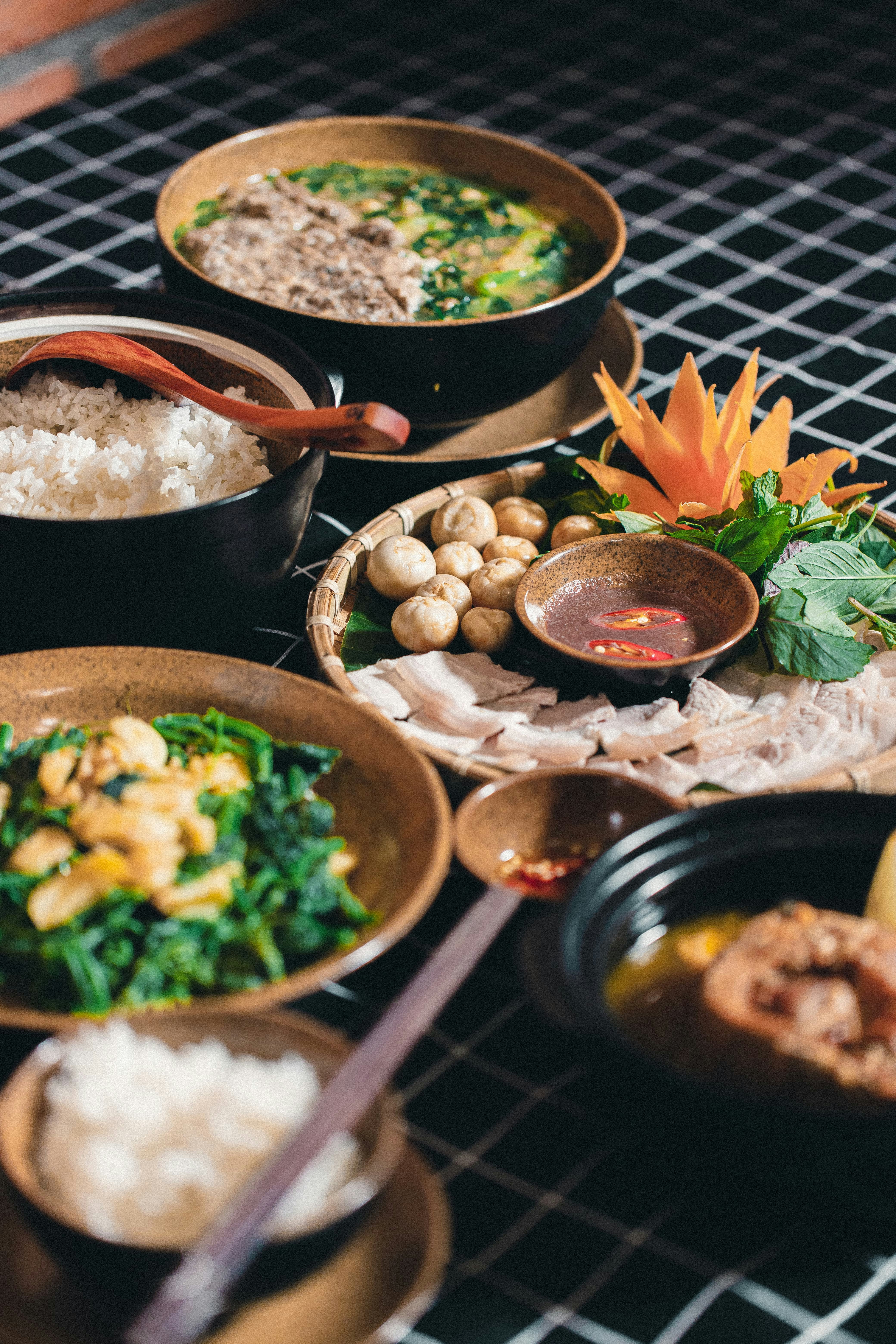 a table topped with lots of different bowls of food