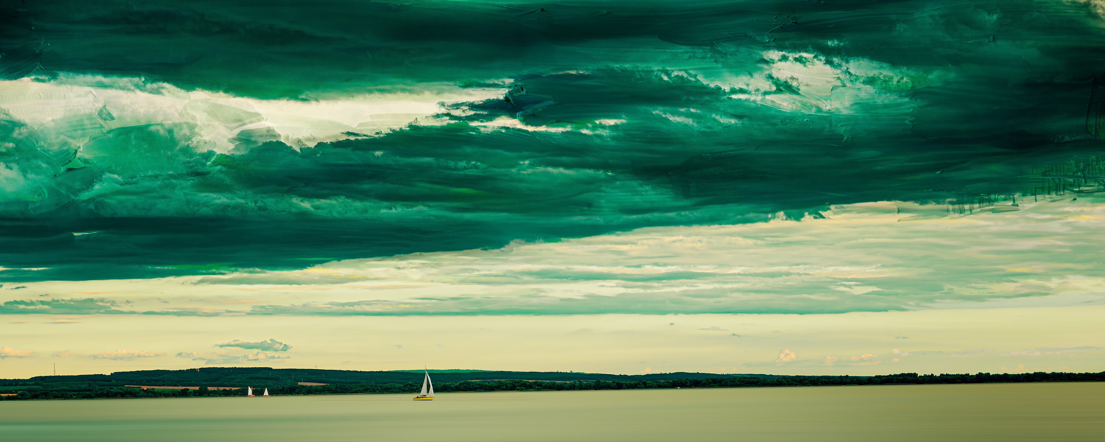 heavily edited photo showing a green tinted lake with sail boats where the sky is modified if it was an oil painting, the rest is normal photography