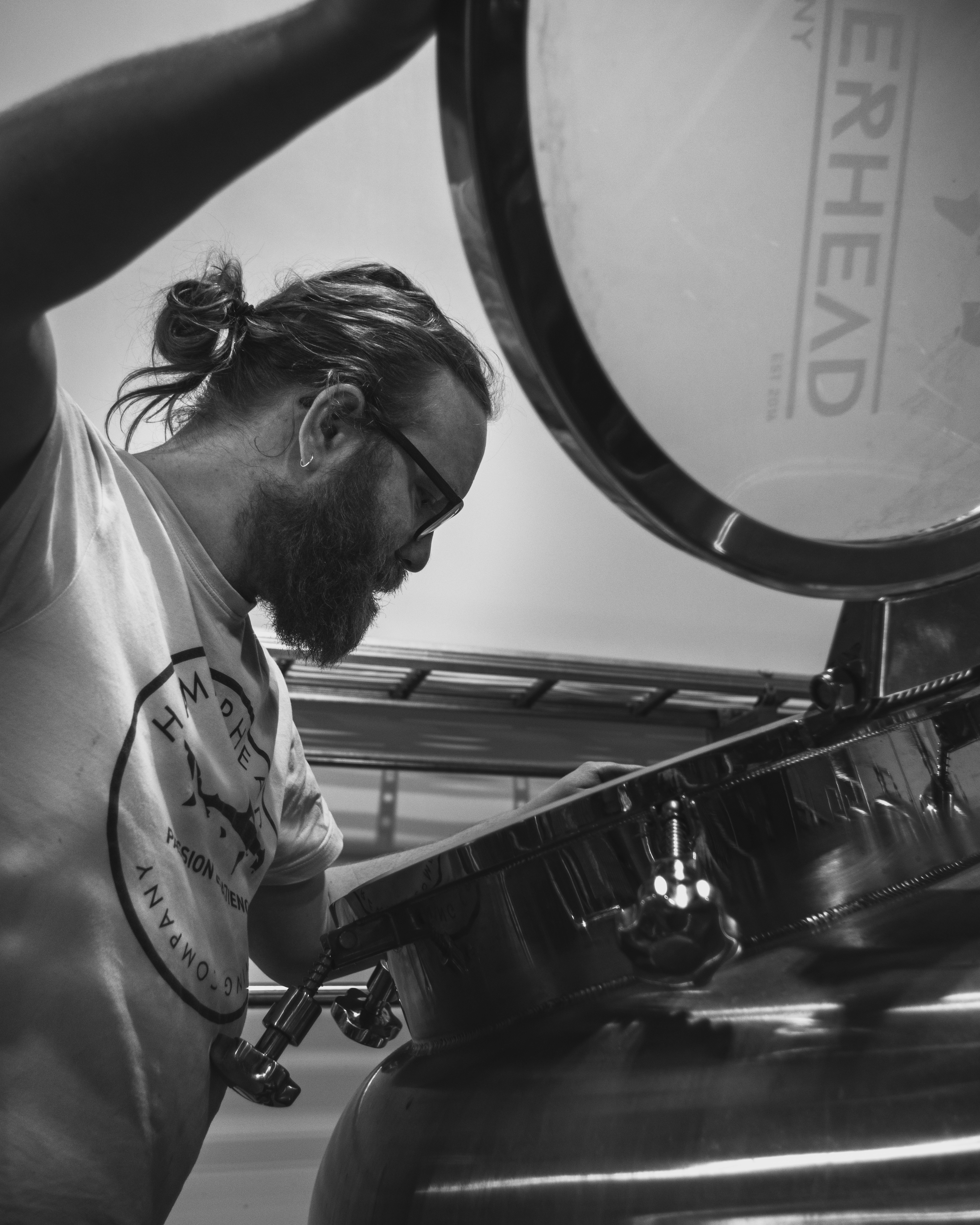 Smiling barista holding green cup at coffee machine