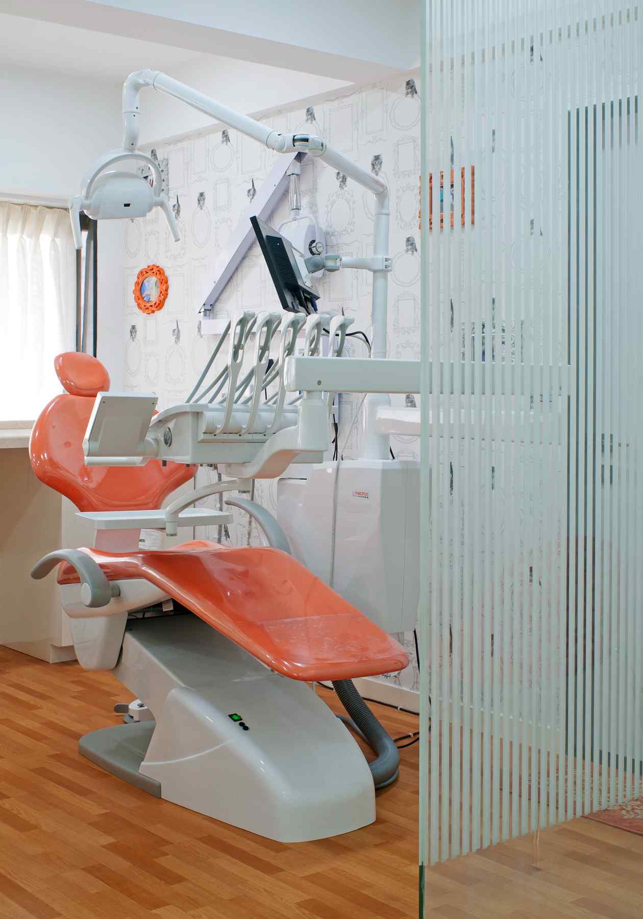 Nature-inspired preschool entrance with sculptural tree partitions and suspended green leaf ceiling panels.