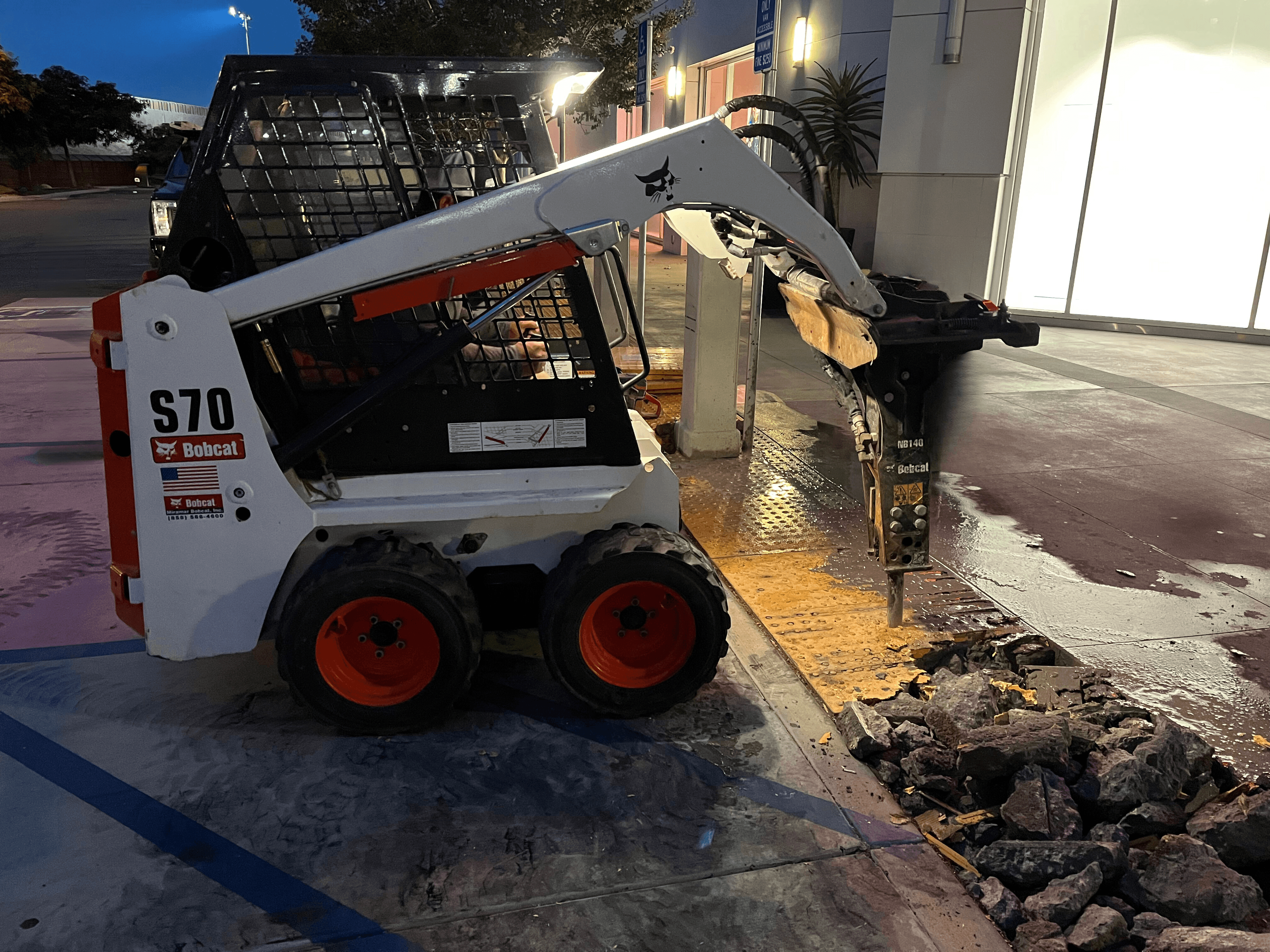 Skidsteer demolishing concrete