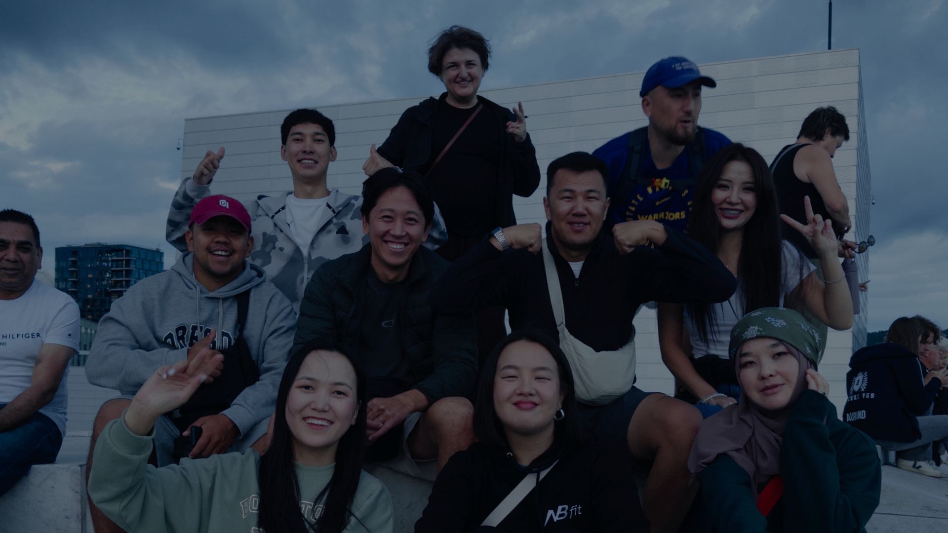 two people sitting on a bench looking at a mountain