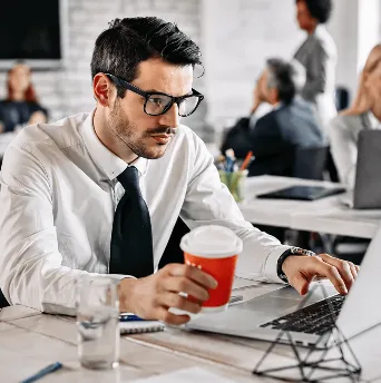 Business professional reviewing financial documents using Sage Intacct accounting software.