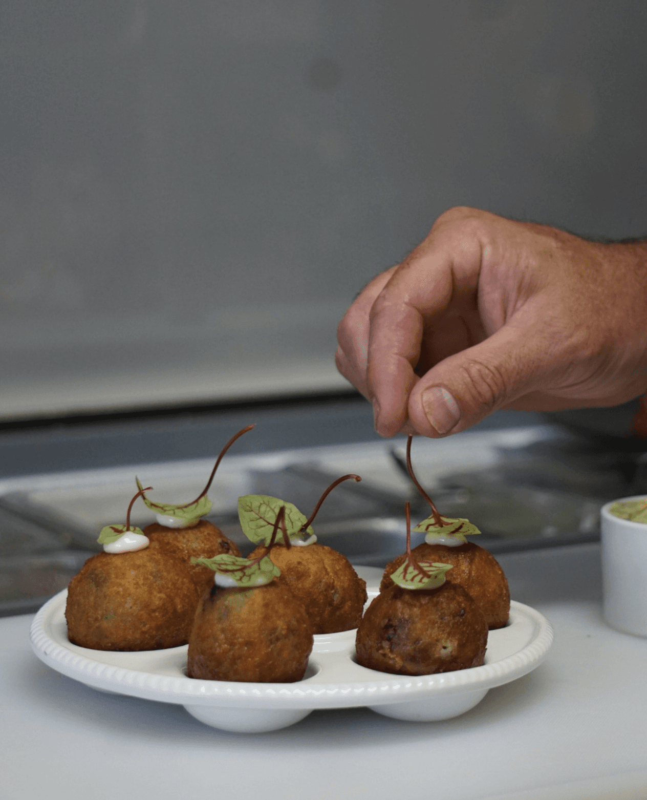 Restaurant bar with guests seated at tables and bartenders at work.