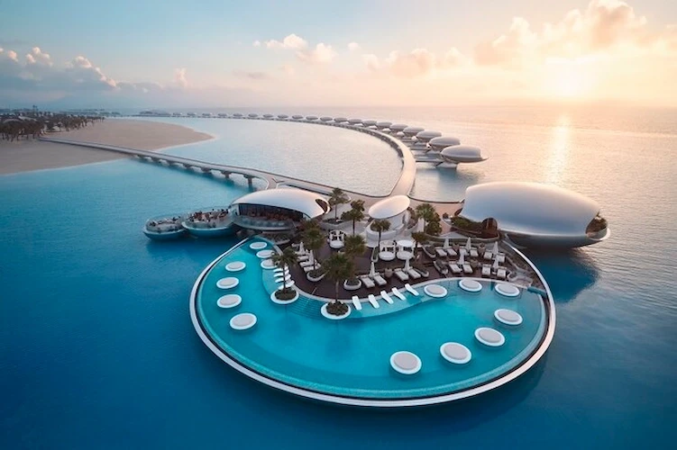 green chairs under umbrellas on shore