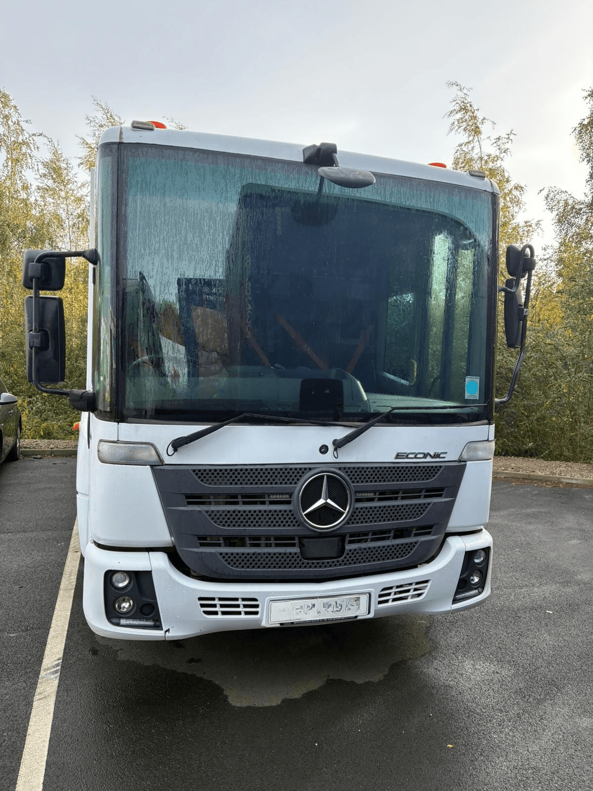 Aerial view of a winding road cutting through rocky terrain and sandy landscape.