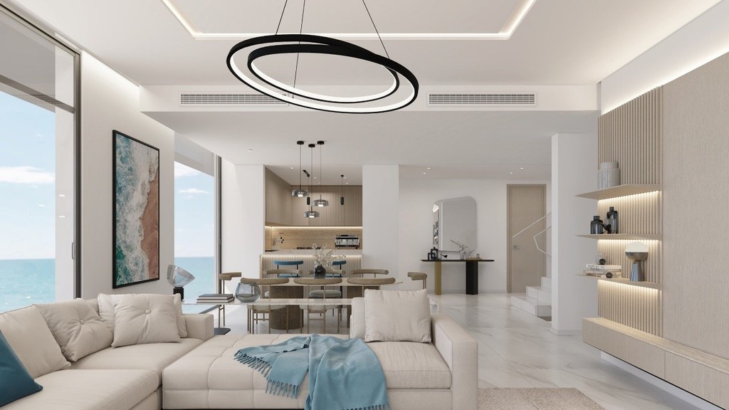 A modern living room featuring a large window with a stunning view of the ocean, designed by Anwa Aria by Omniyat.