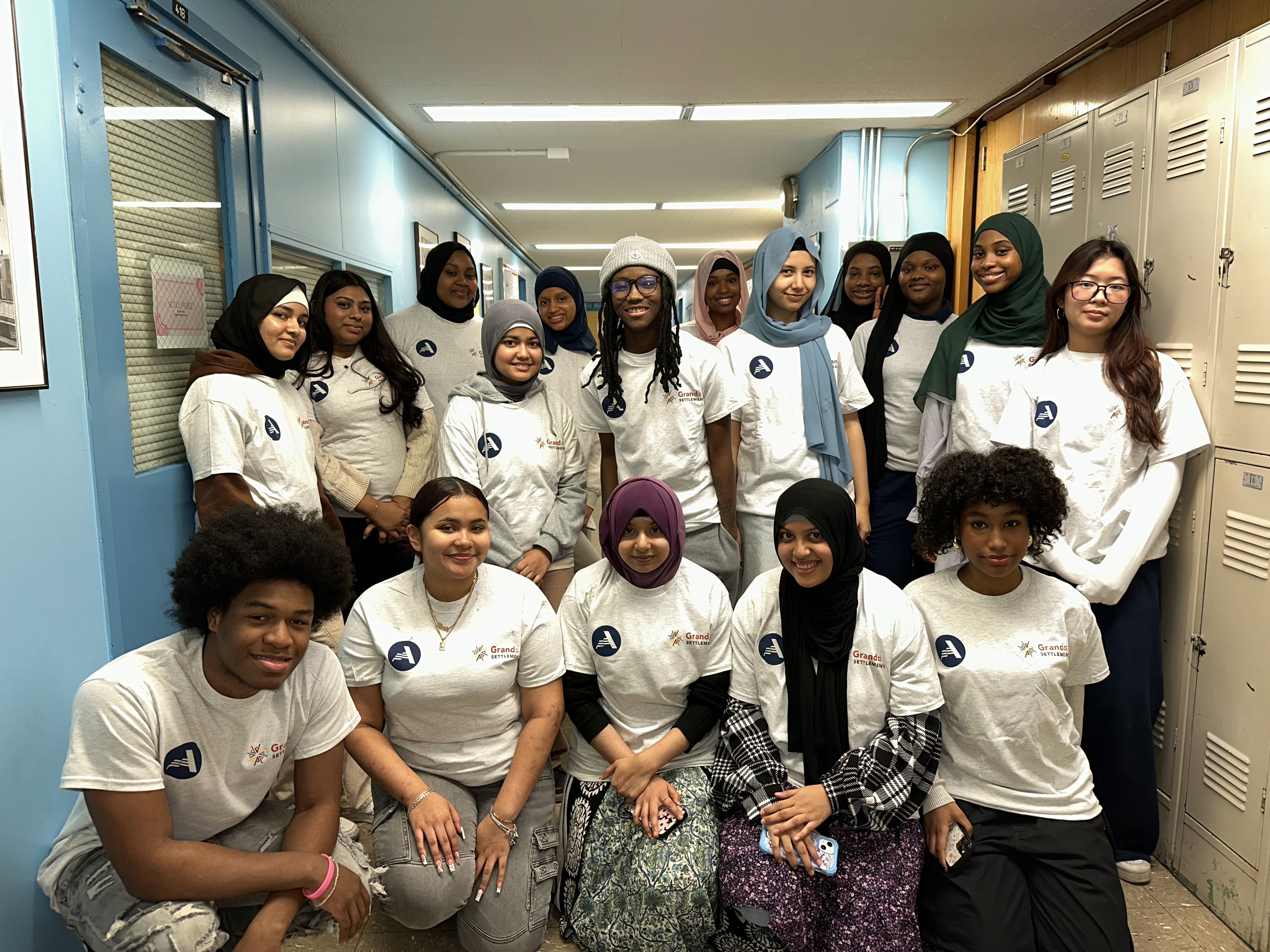 AmeriCorps volunteers pose in a hallway.