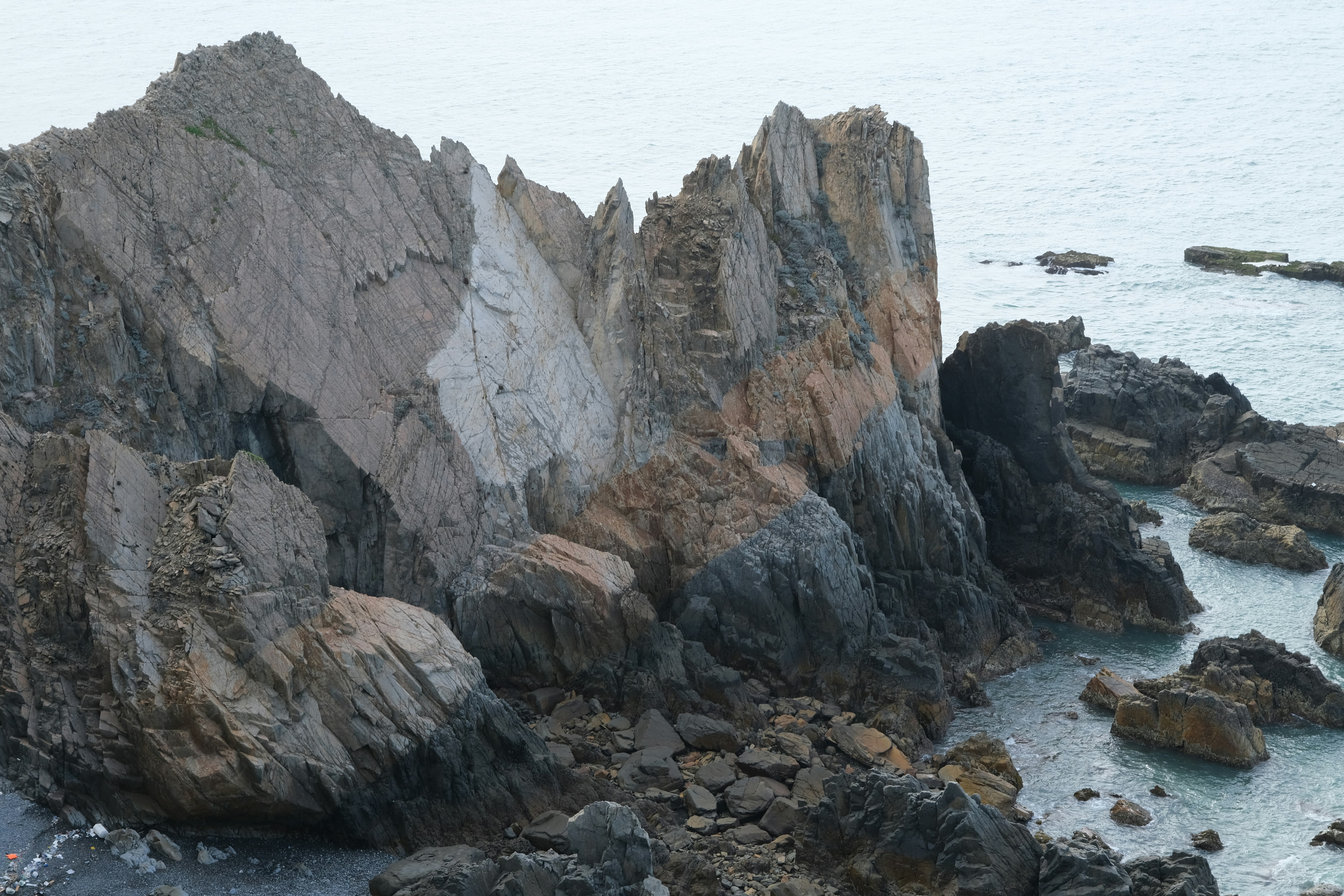 Jagged rock formations along a rocky coastline.