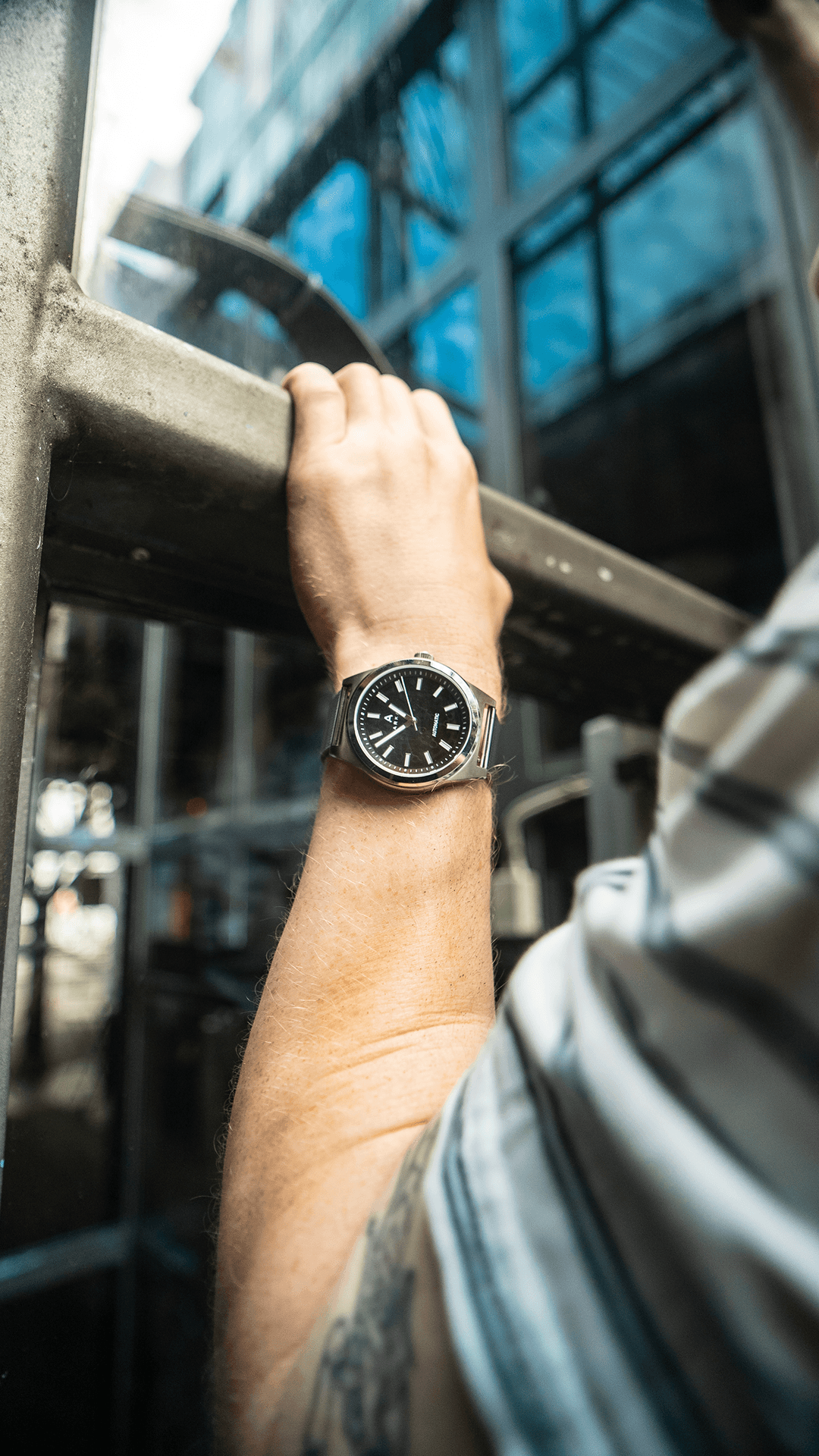 A close-up of an open book with layered fabric swatches. The left page has cool blues and greens, while the right shows warm yellows, oranges, and reds.