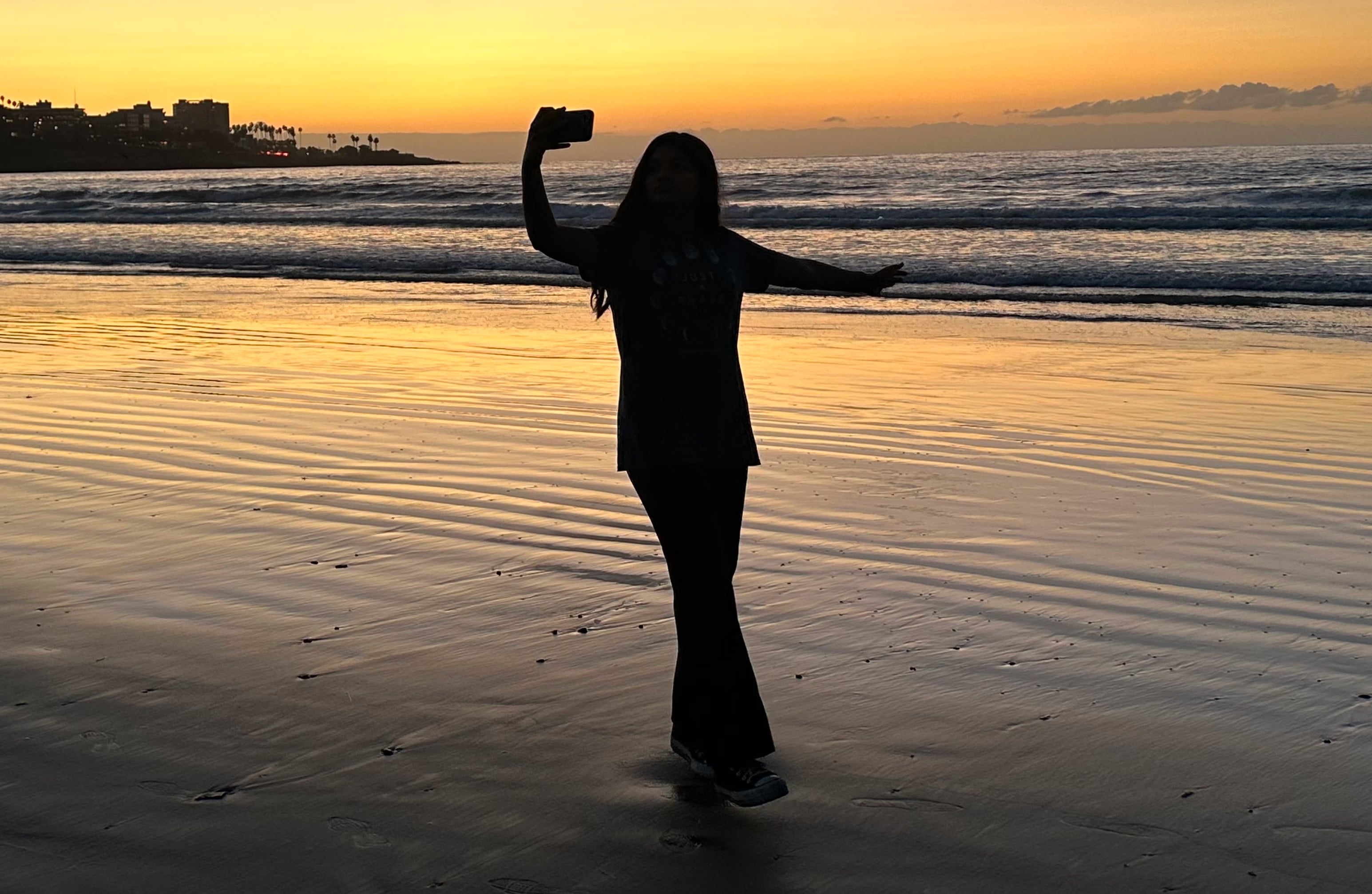 Inaaya reflecting in the sunset on a beach