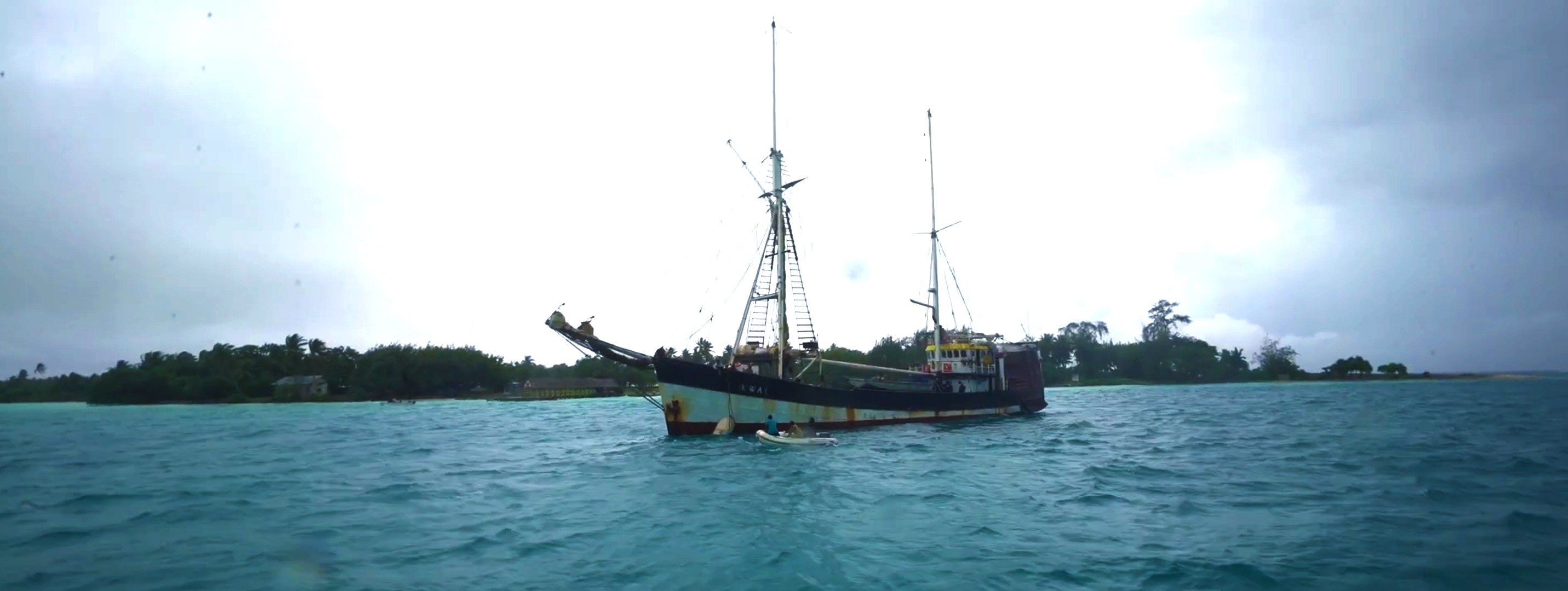 woman holding a phone and man looking at the phone. both are smiling