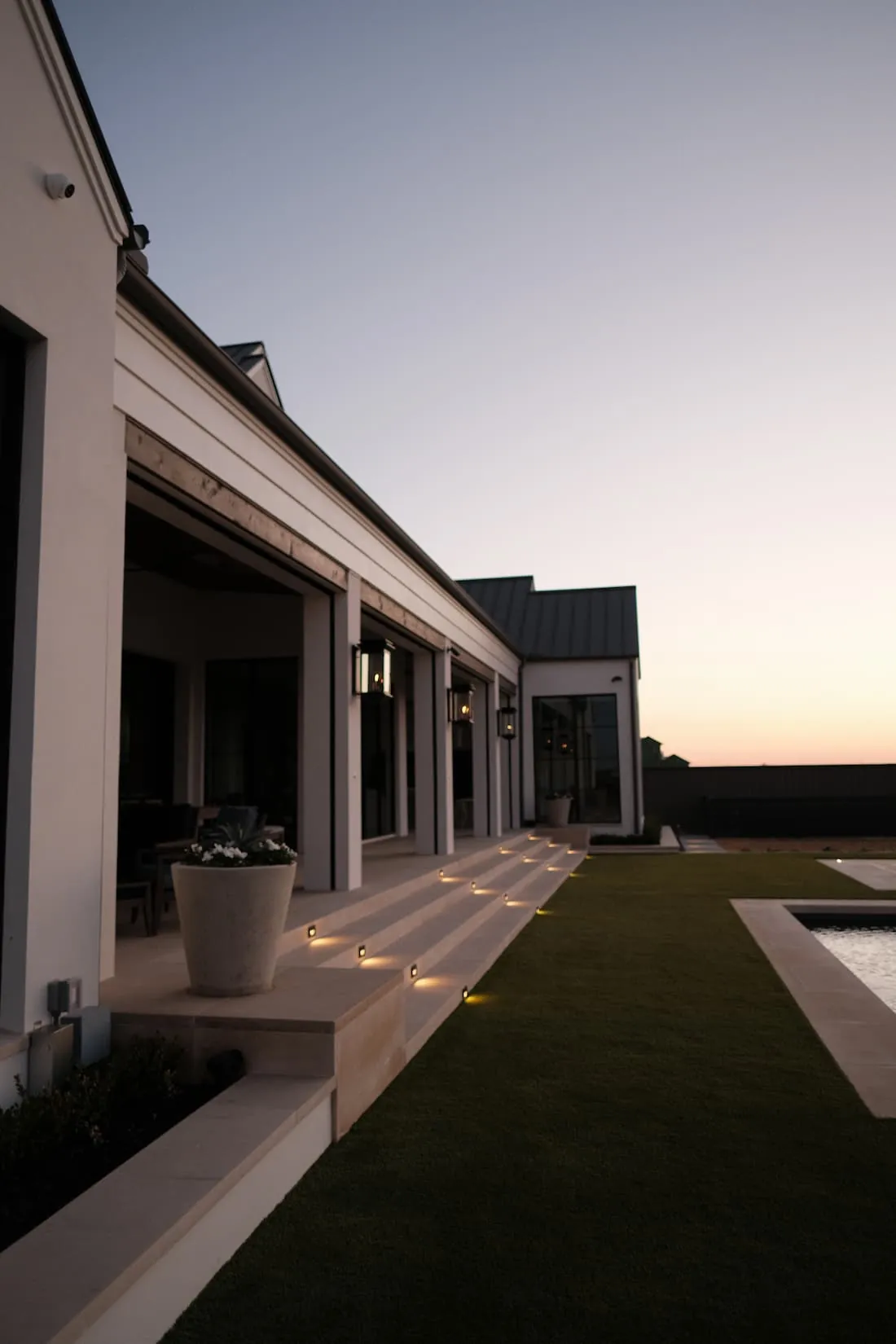 Limestone terrace step lighting at dusk, landscape design by Blount Designs