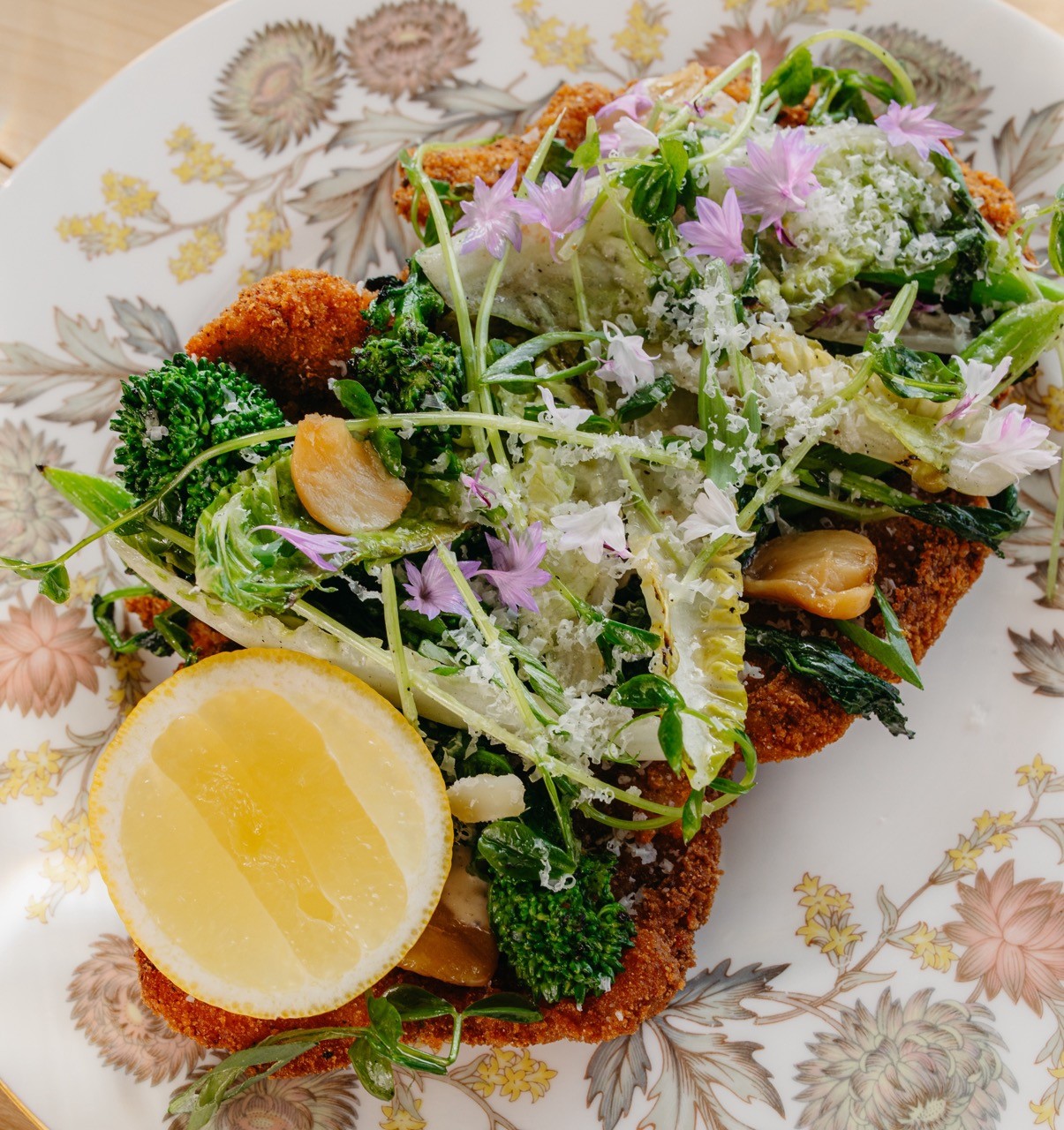 Crispy pork w/ grilled rapini, greens, caesar vinaigrette, & an anchovy, preserved lemon, & parmesan emulsion