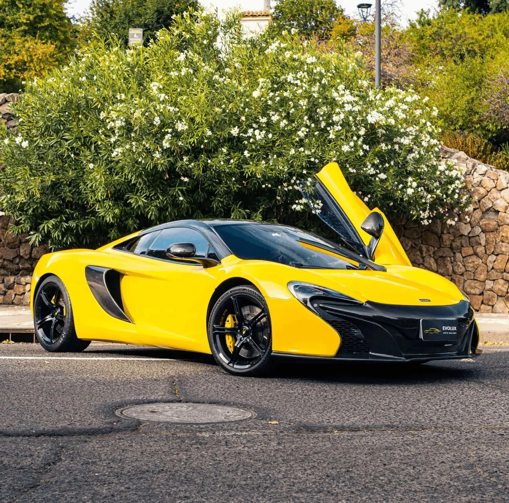 McLaren MP4-12C gris estacionado en exterior, vista frontal lateral baja y deportiva