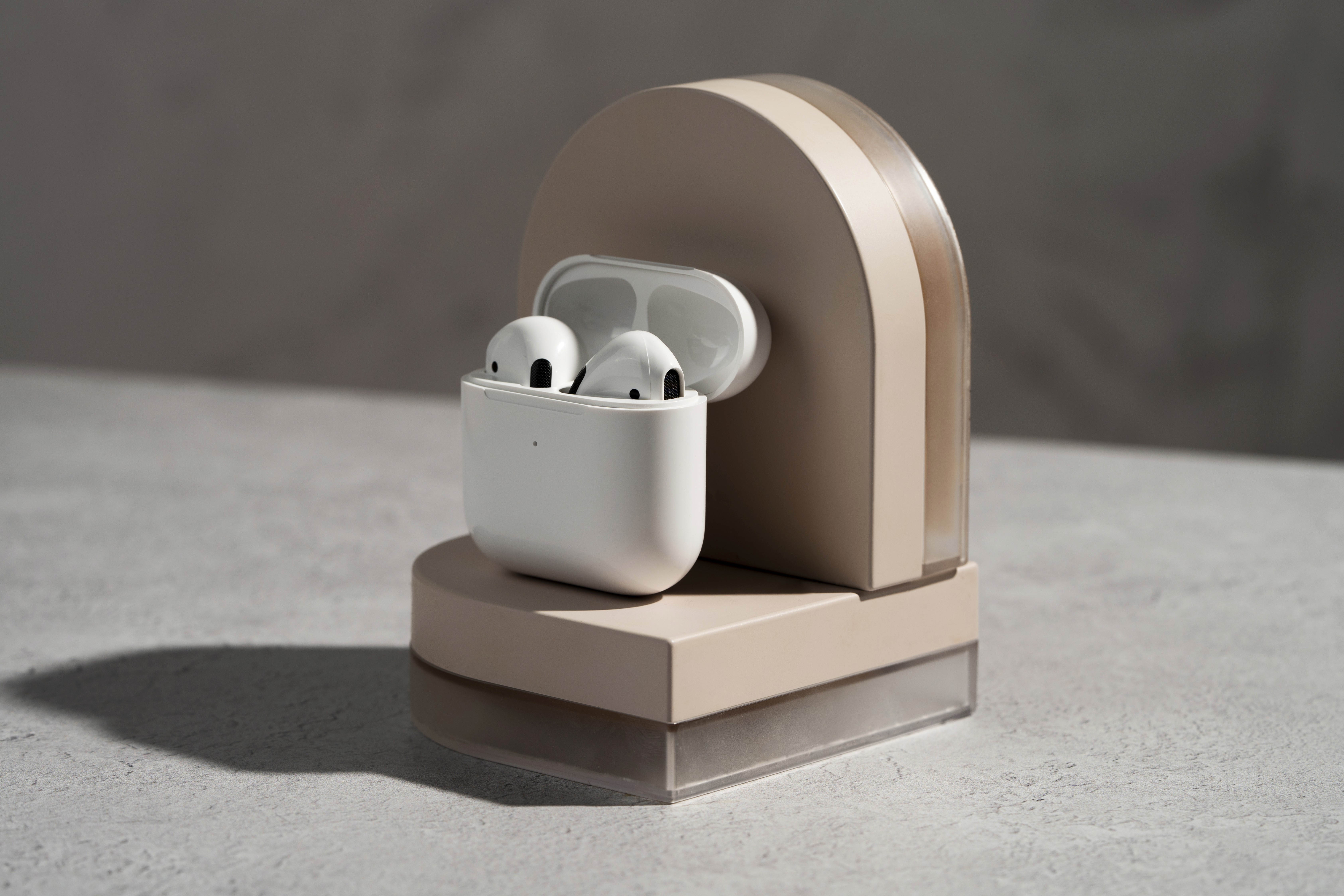 White earbuds place on wooden surface.