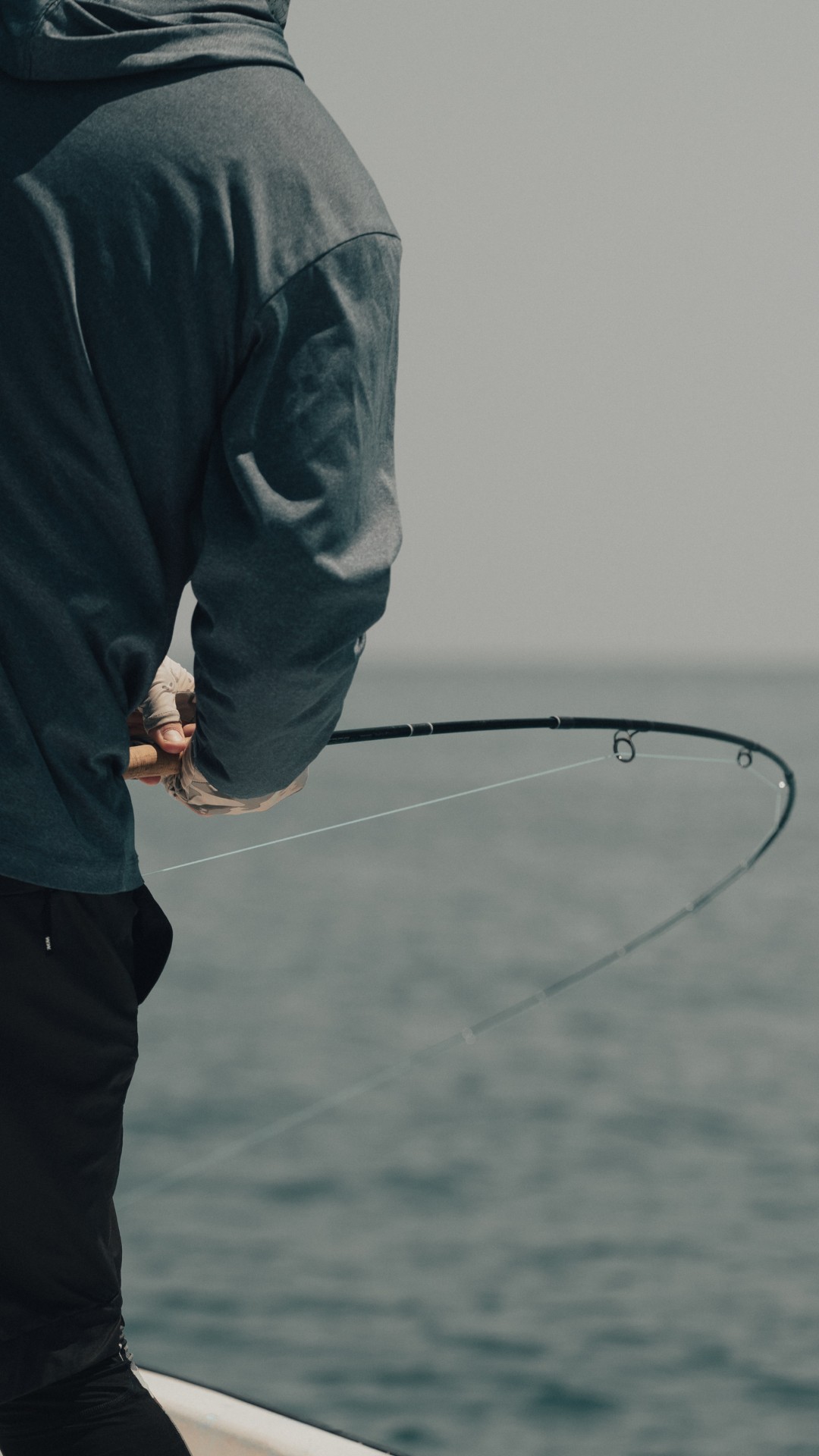 Angler holding a bent fly fishing rod