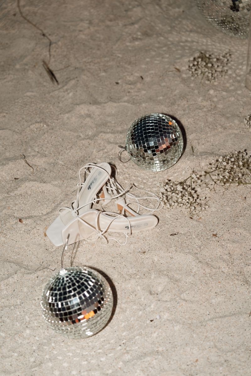 A beautifully set dining table with white tablecloth, cutlery, and fresh greenery in a cozy, well-lit space.