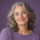 Portrait of Elena, smiling woman with grey wavy hair