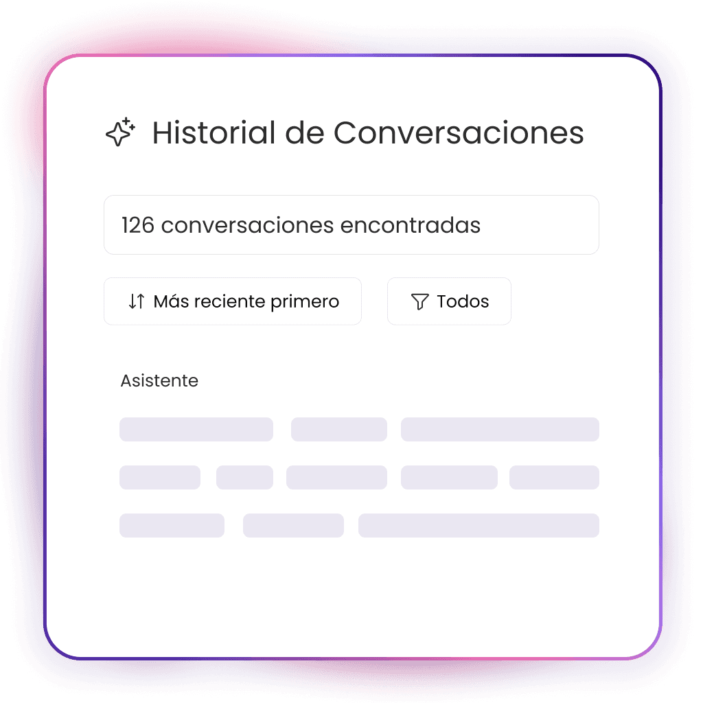 A young person with curly hair smiles at the camera while sitting in front of a laptop against a dark background.