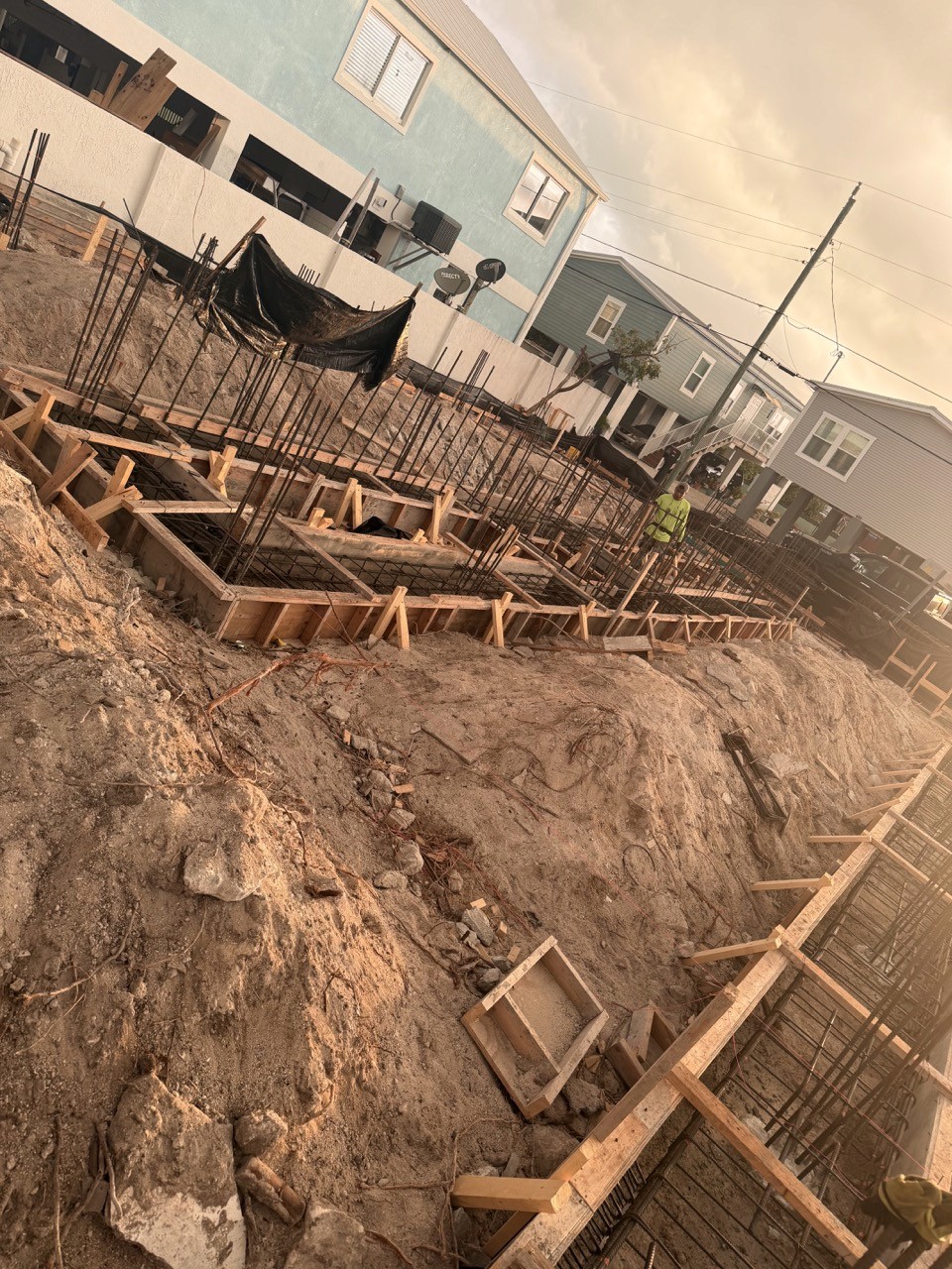 Modern living room with abstract art, beige sectional sofa, indoor plants, and large windows.