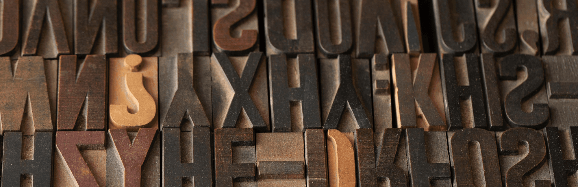 Random letters engraved to form a wooden pattern