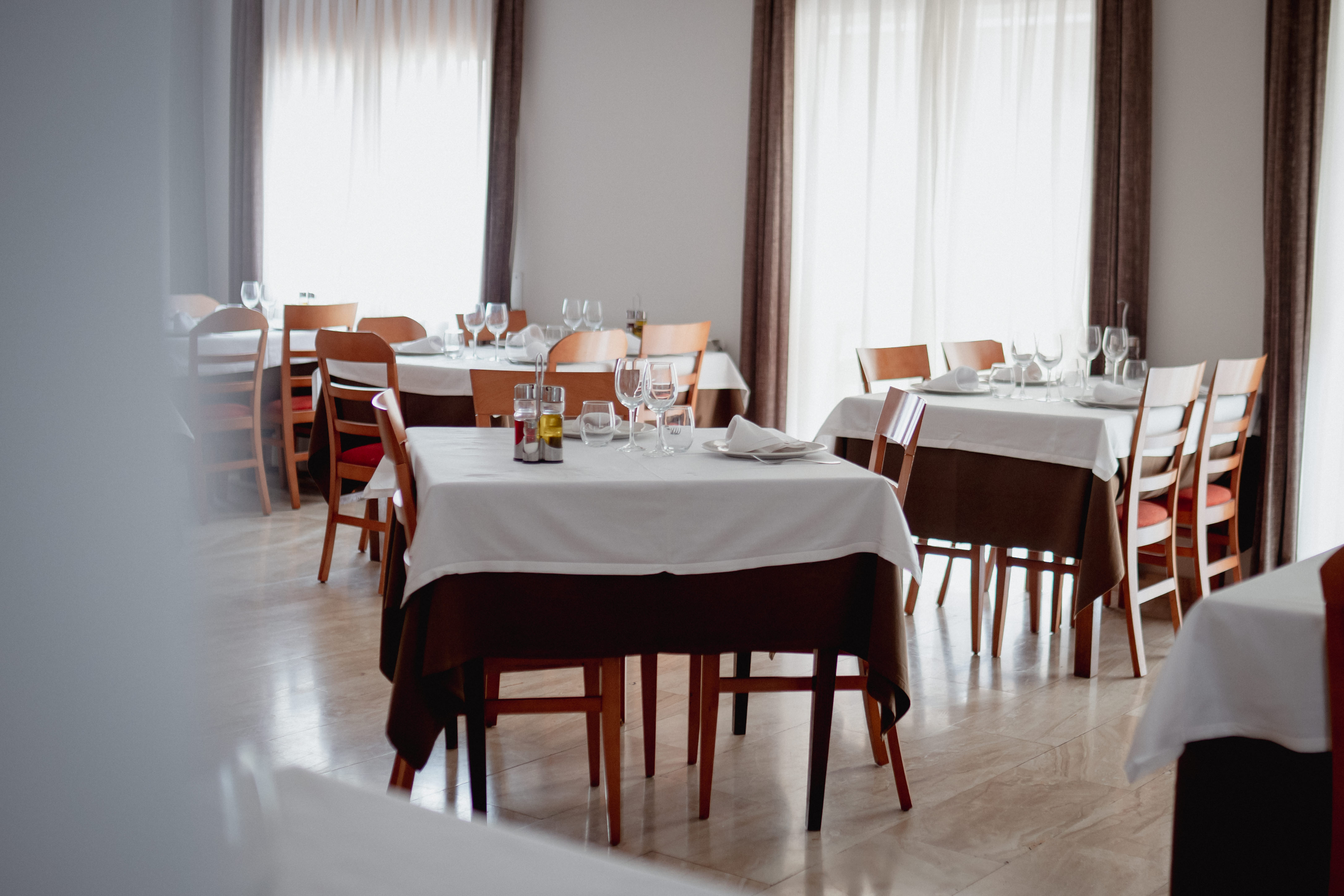 Posh restaurant interior with blue walls and large chandelier in the center