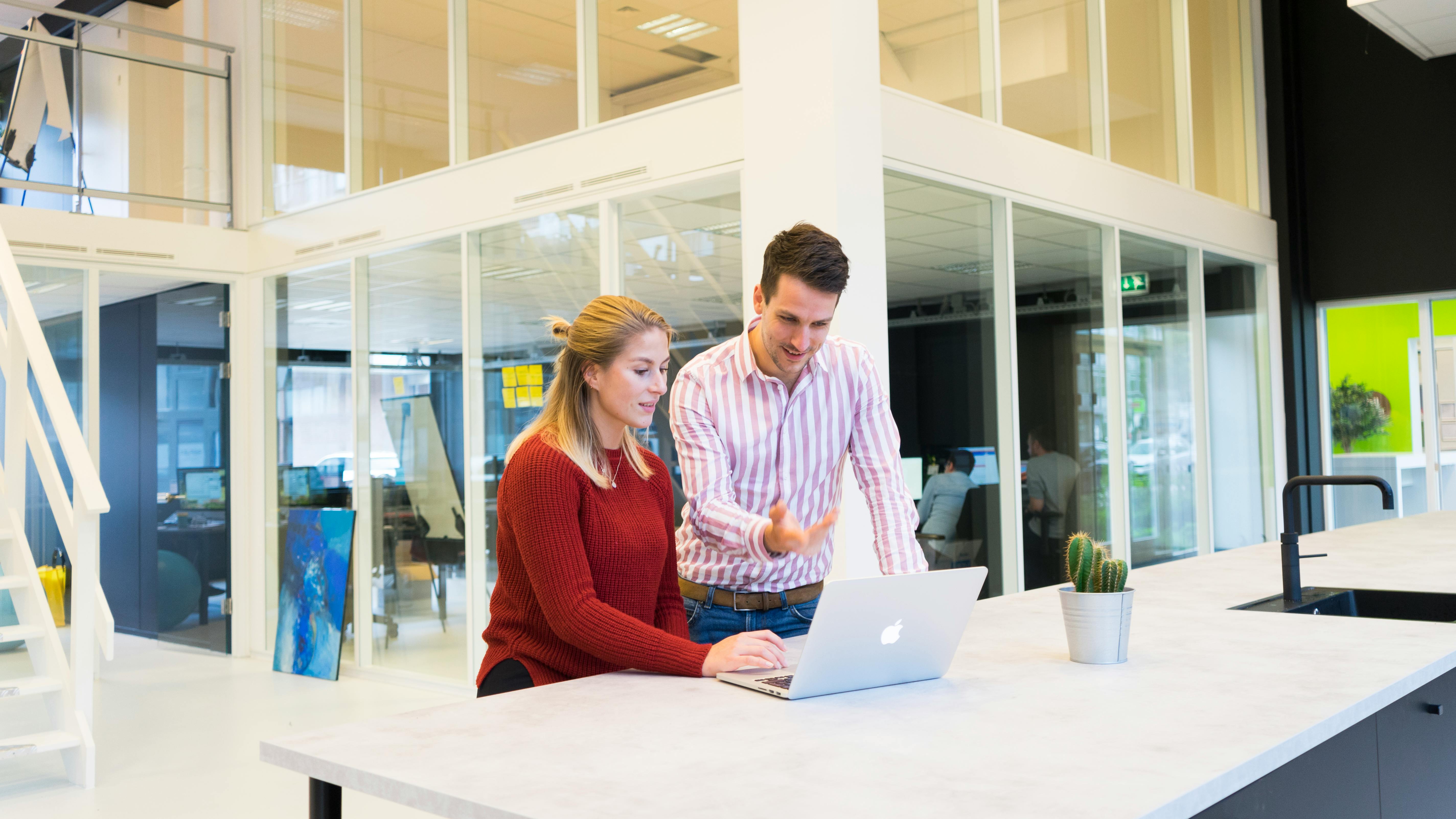 Man and woman using laptop to master outreach