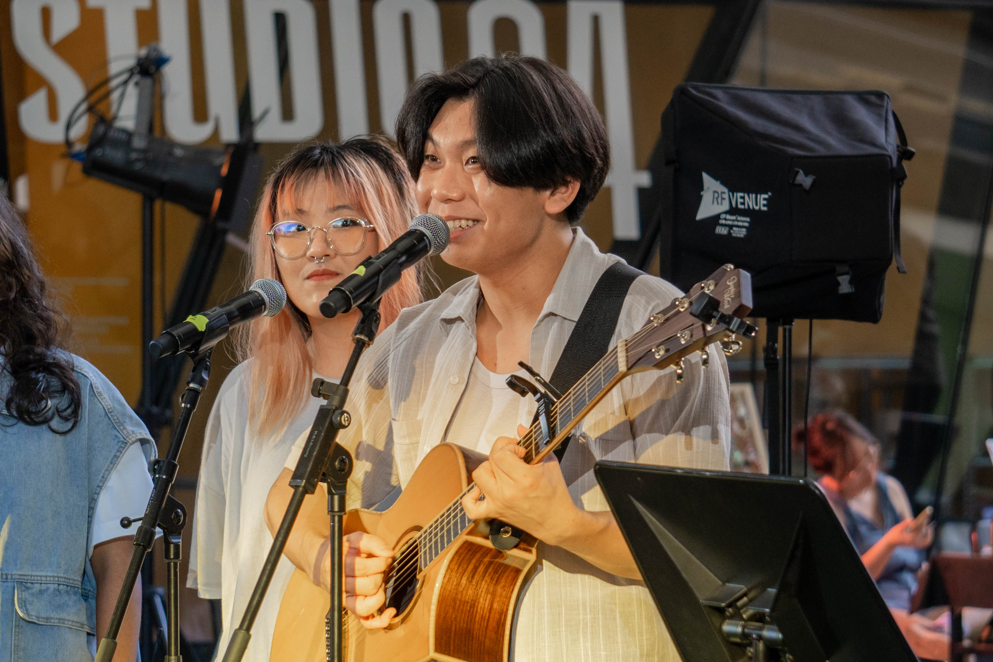 Ezekiel playing the guitar with a smile for the audience