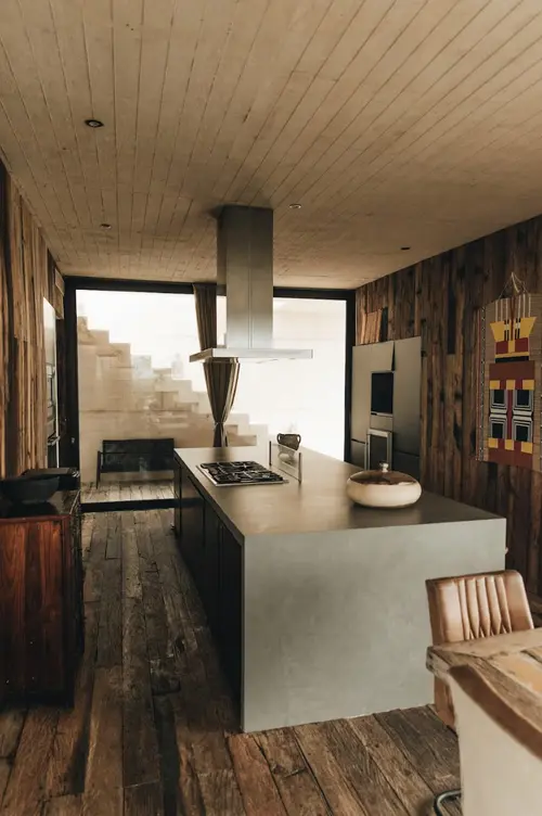 Beautiful Casa Sastran kitchen with range hood, breakfast bar, and dining area.