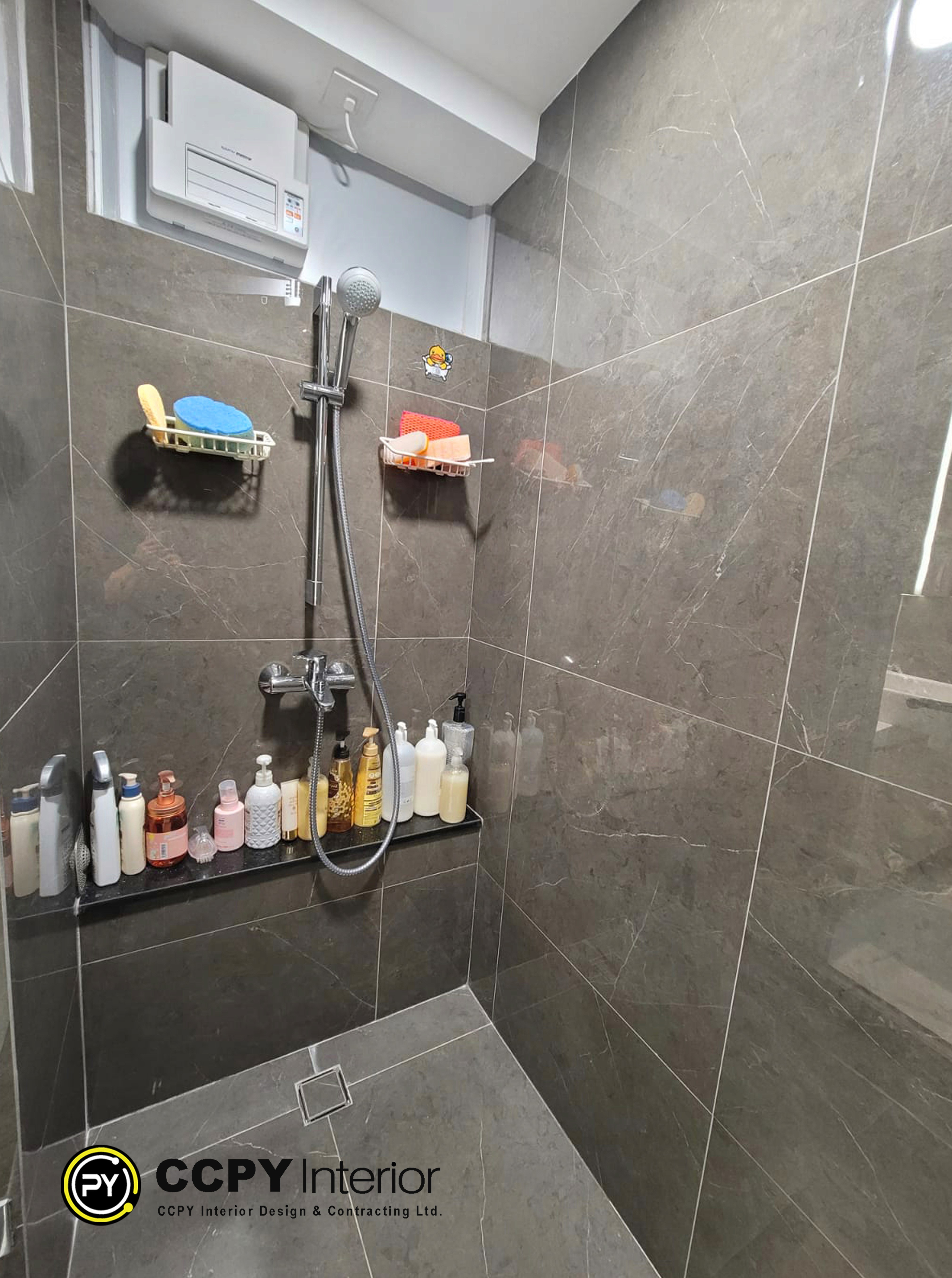 The chosen area displays a contemporary bathroom with a sleek, multipurpose shower system and dark stone-textured porcelain tiles. This bathroom is constructed with high-end fixtures, such as a TOTO smart toilet and a Kusatsu bathroom heater/ventilation fan, according to the design notes in the paper. The particular material and fixture selections that were emphasized for this area are broken down as follows: Materials & Fixtures for Bathrooms Porcelain tiles with a dark stone texture for walls and floors. Cabinetry: Vanity cabinet with wood grain. Mirror: A mirror cabinet made of solid wood. Ventilation: Kusatsu ventilation fan and bathroom heater. The TOTO smart toilet.