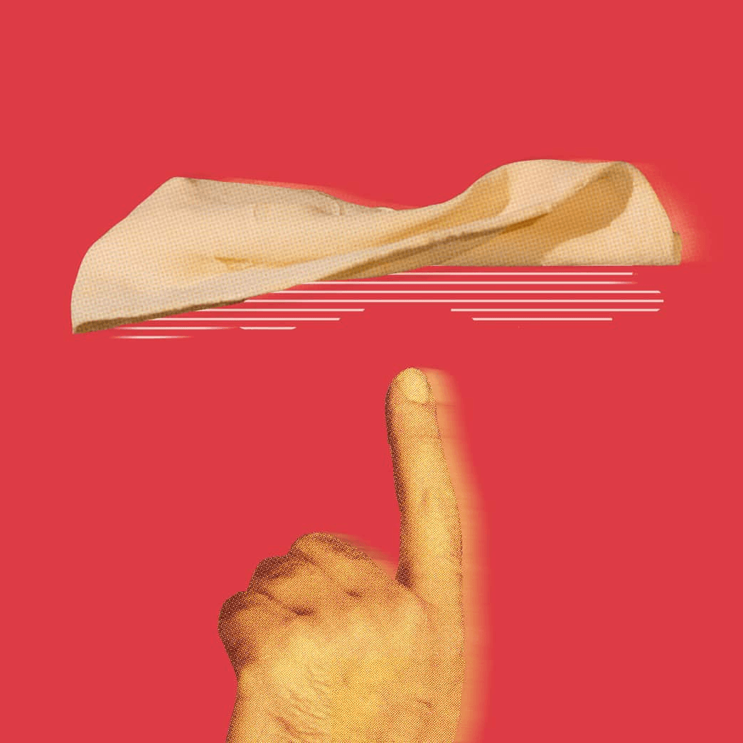 Dedo apuntando hacia un trozo de pan  que gira en un fondo rojo.